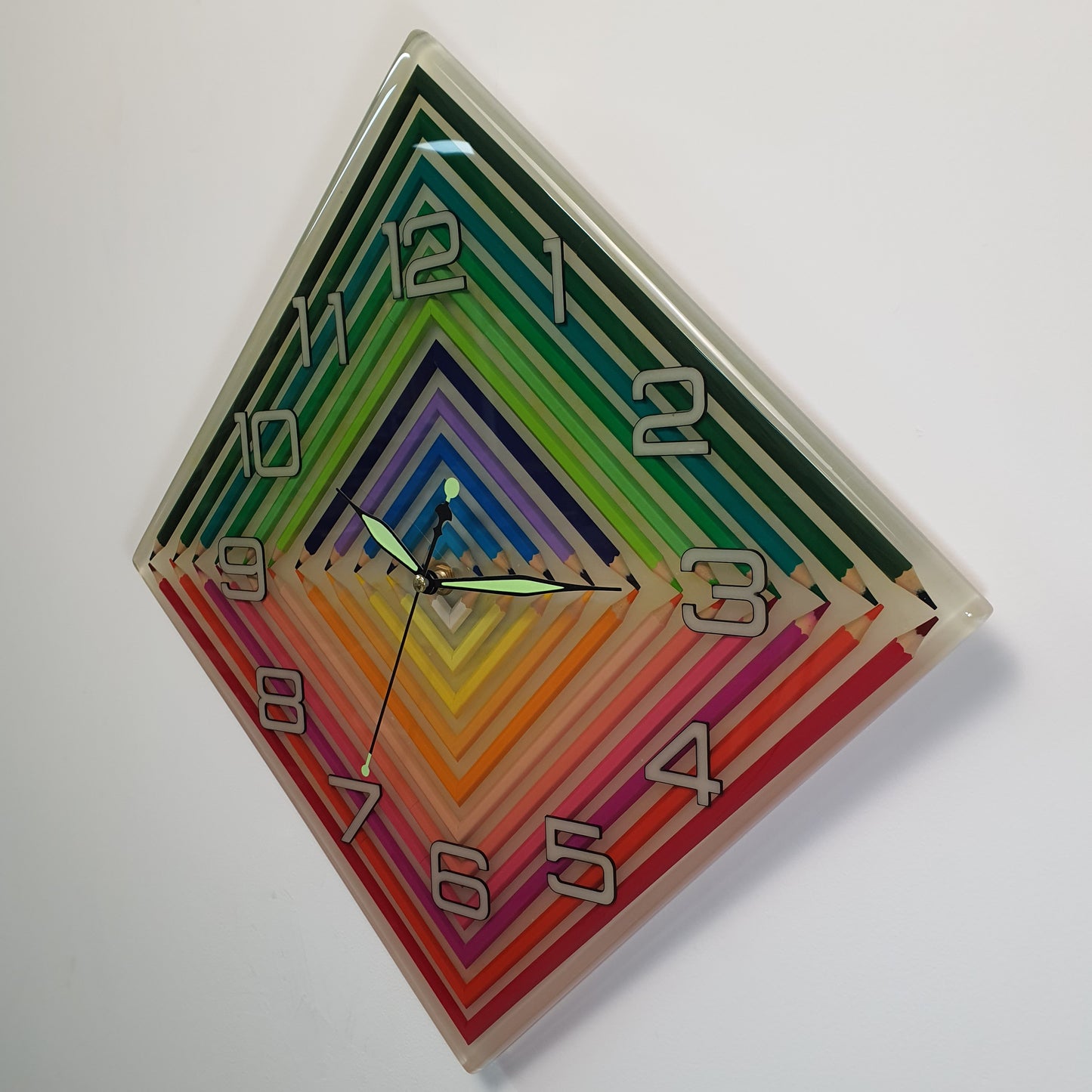 Angled side view showing depth of layered epoxy rainbow wall clock