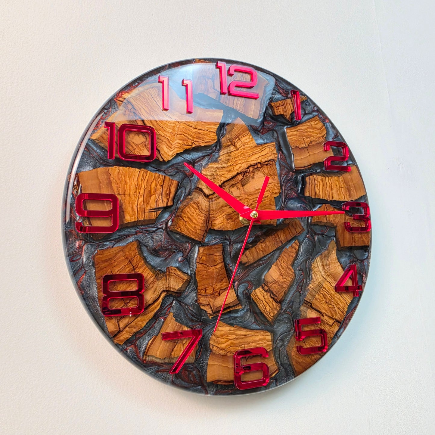Contemporary wall clock featuring olive wood, resin and red mirrored markers