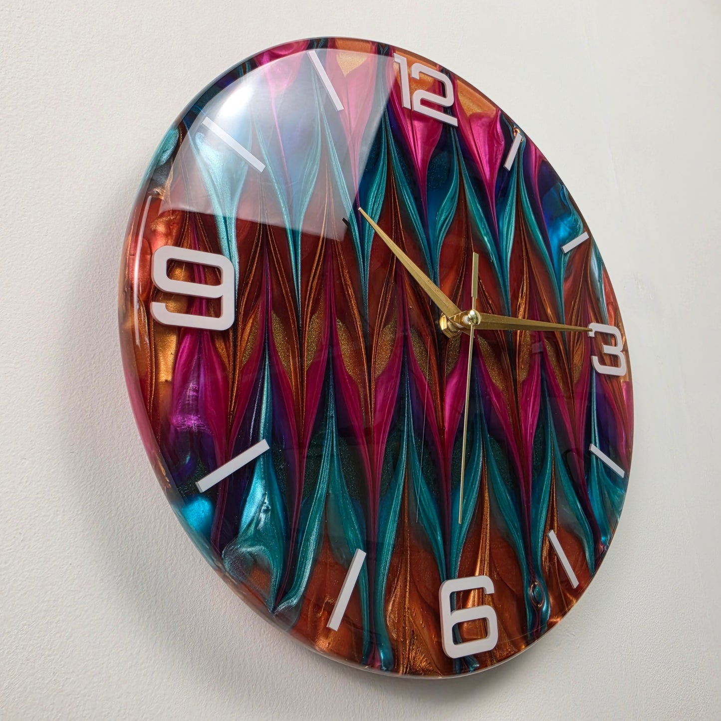 Unique abstract resin clock created with a signature color-blending technique in vibrant turquoise, magenta and gold tones.