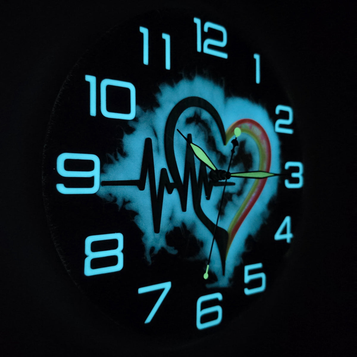 One-of-a-kind heart and ECG wall clock transforming from colorful chameleon art by day to glowing functional art at night.