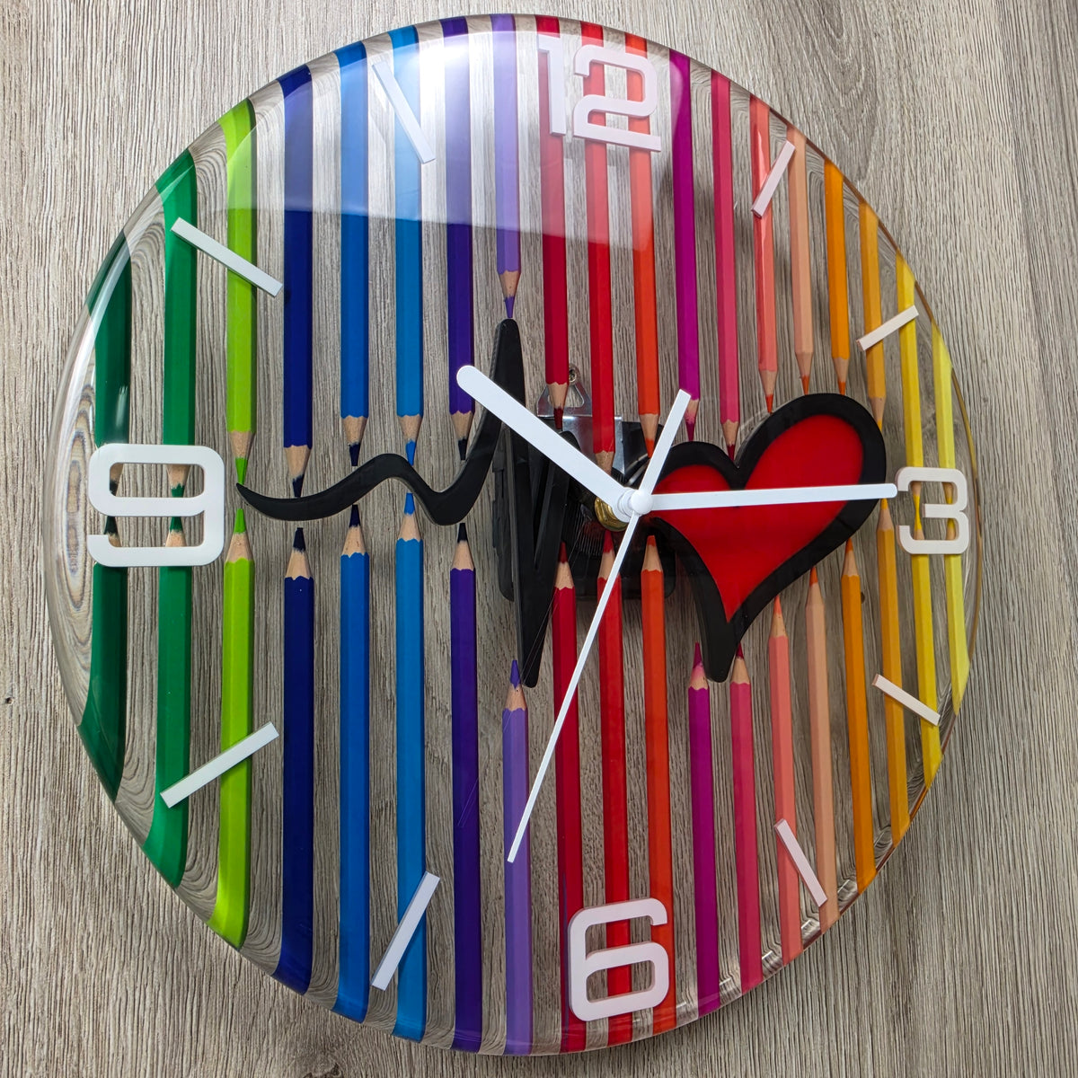 Modern epoxy resin clock with transparent background, rainbow pencils and red heart