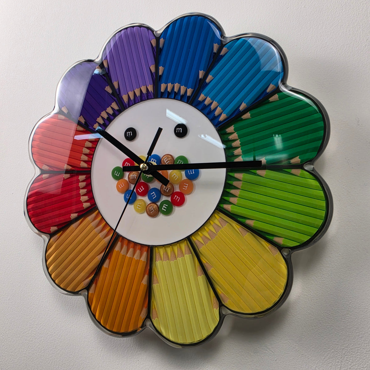 Handmade Italian wall art clock featuring a rainbow flower design with real colored pencils preserved in resin.