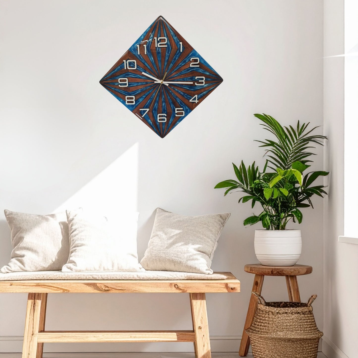 Interior shot – Walnut Wave clock hanging on a white wall above a wooden cabinet with plant