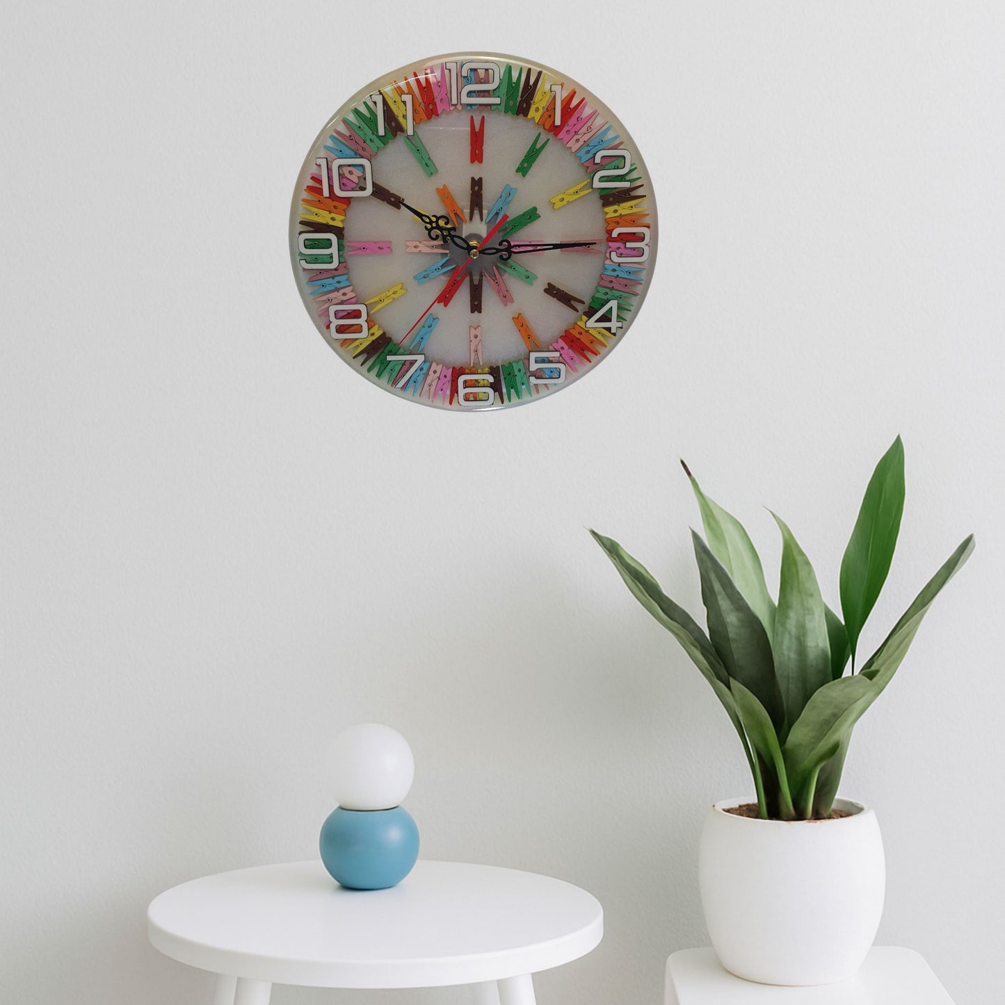 Happy Pegs clock displayed on a modern interior wall