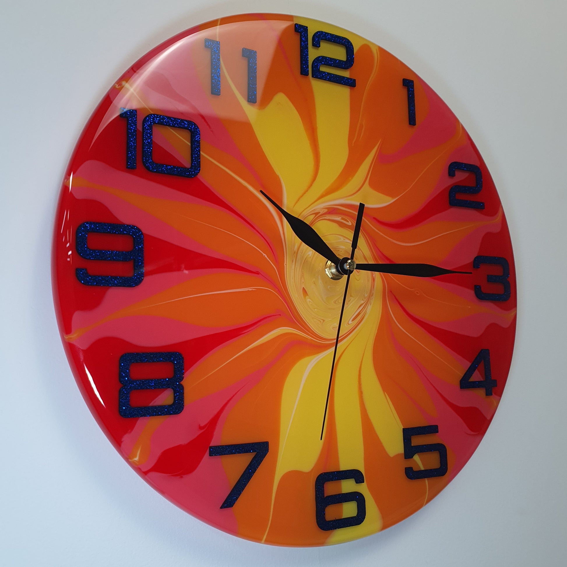 Angled right-side view of the "Fire Bloom" wall clock – showing color flow and epoxy depth