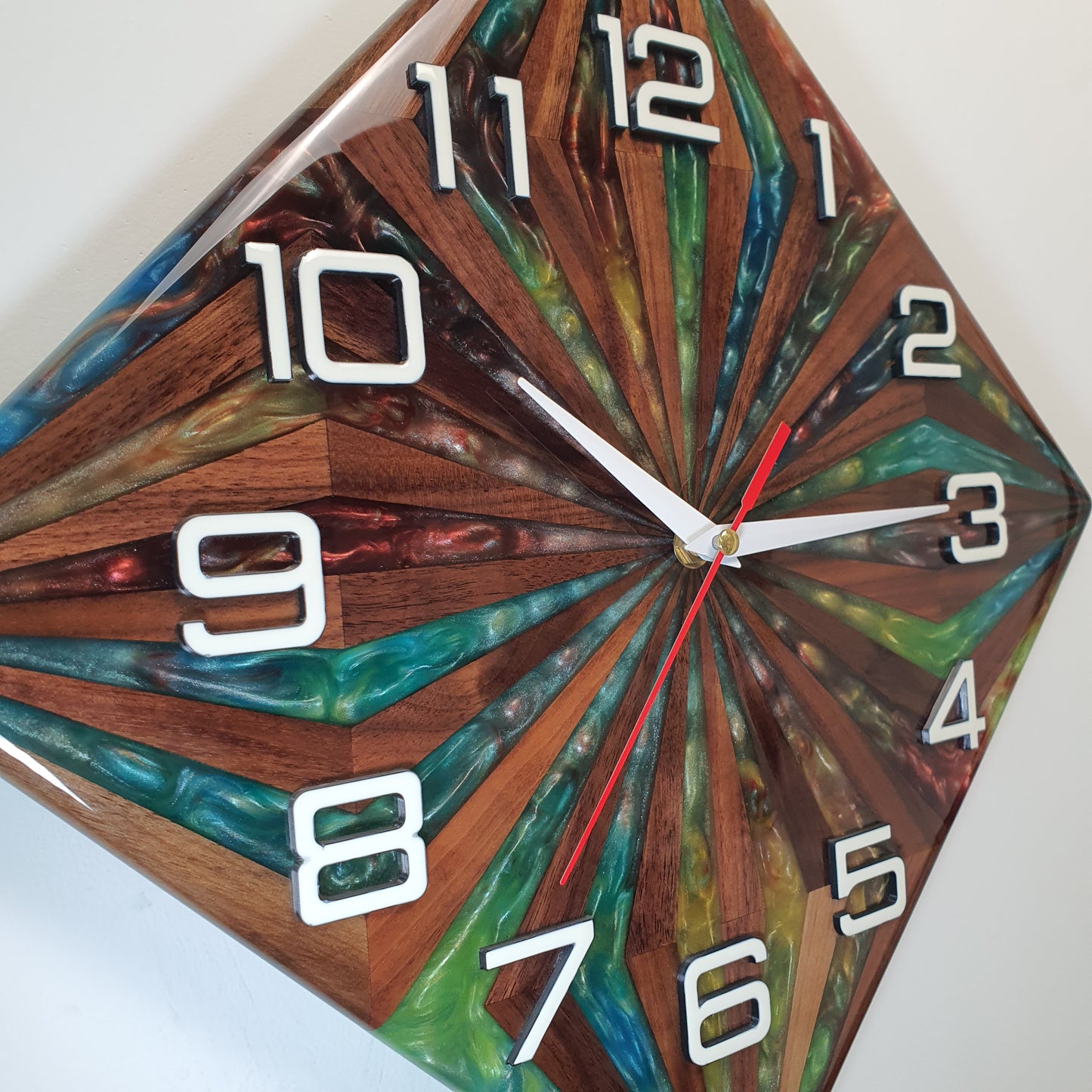Close-up of the "Walnut Prism" clock face – resin details and natural walnut grain under glossy surface