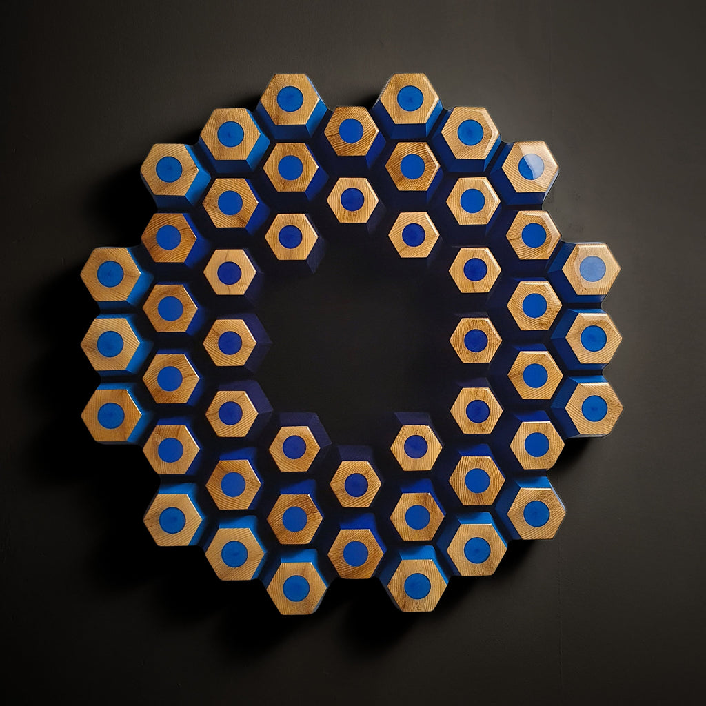 Minimalist geometric wall sculpture with layered blue wooden modules and ultra black center depth