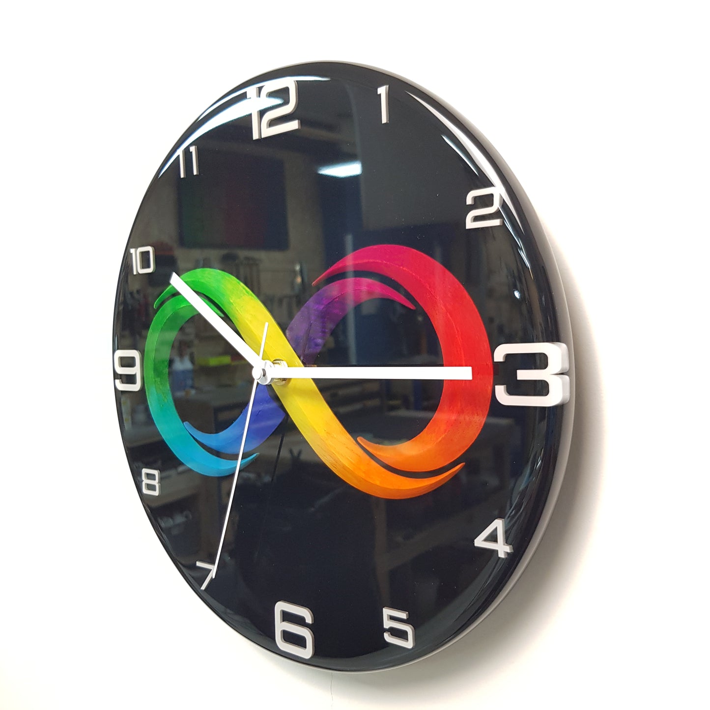 Right side angle view of the Black Infinity wall clock with reflective black surface and clean modern design