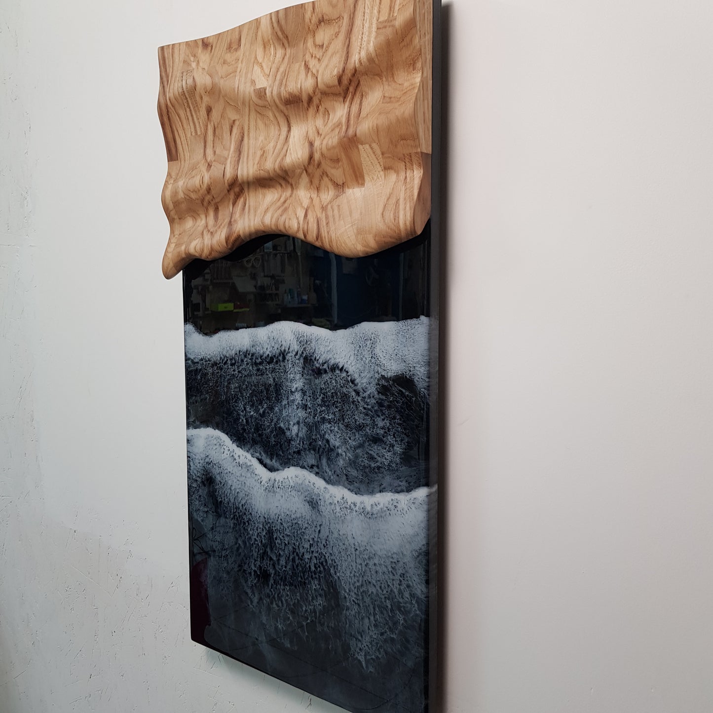Minimalist wooden wall sculpture with textured resin waves