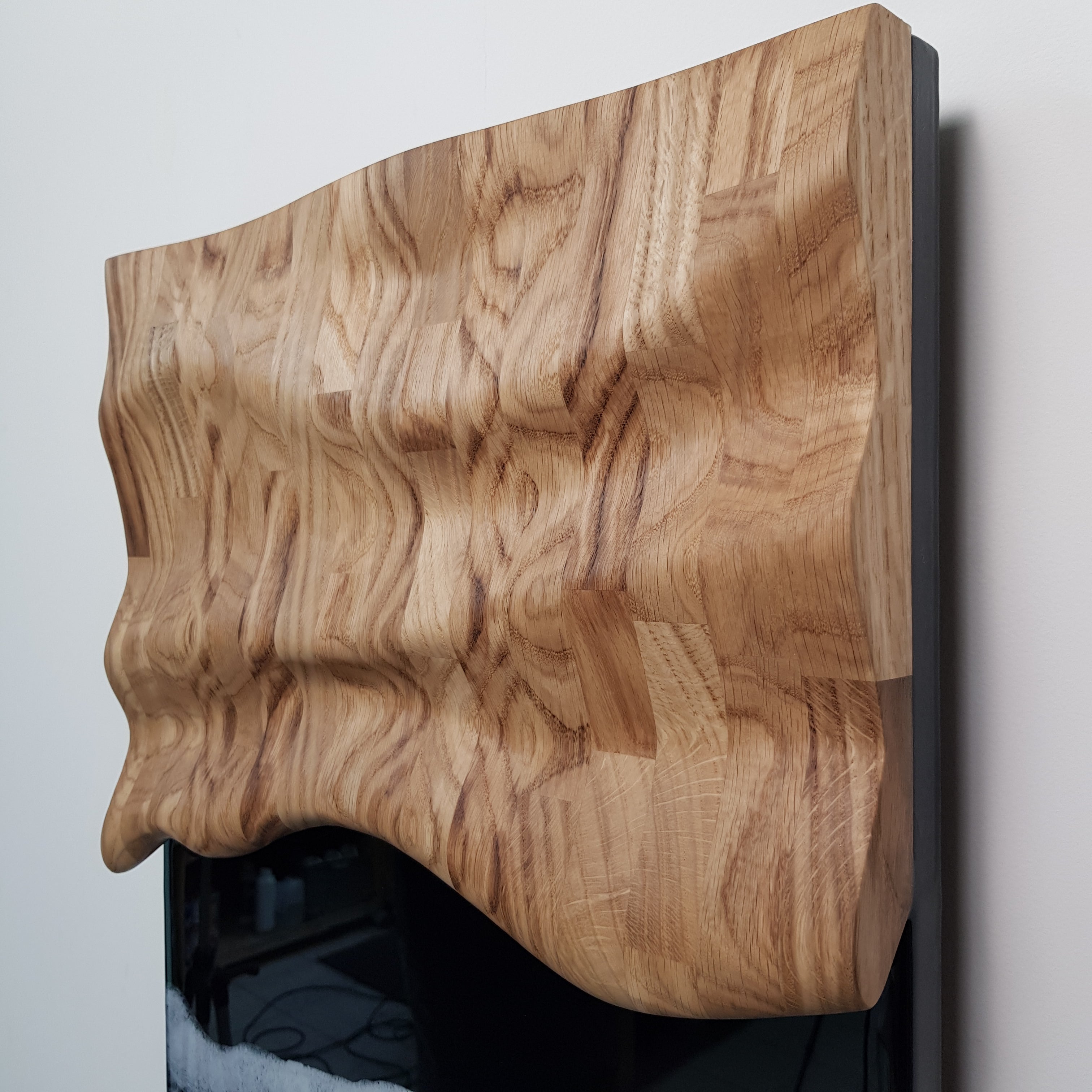 Contemporary ocean-inspired wall sculpture — carved oak and resin detail