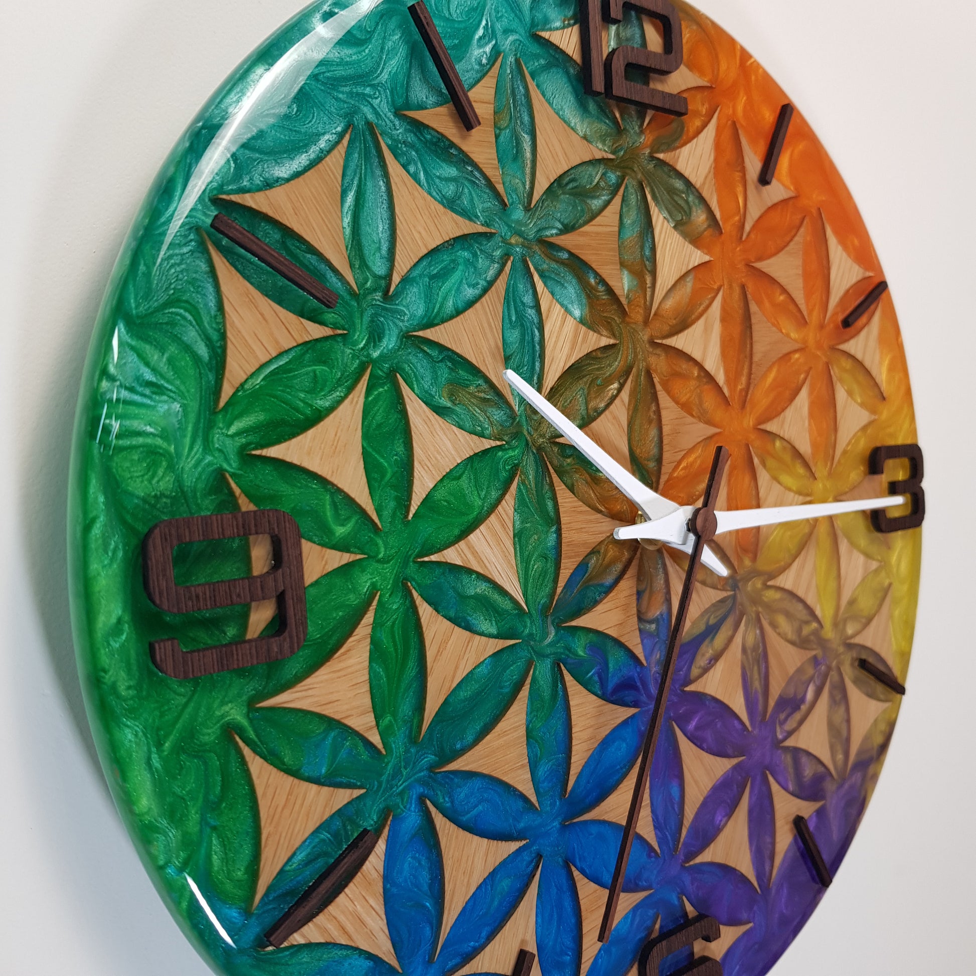 Close-up of Life Essence clock – detailed look at the epoxy resin colors blending over the carved oak wood surface.