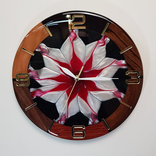 Front view of the “Frozen Flame” wall clock showing the red-and-white resin center and gold plexiglass markers