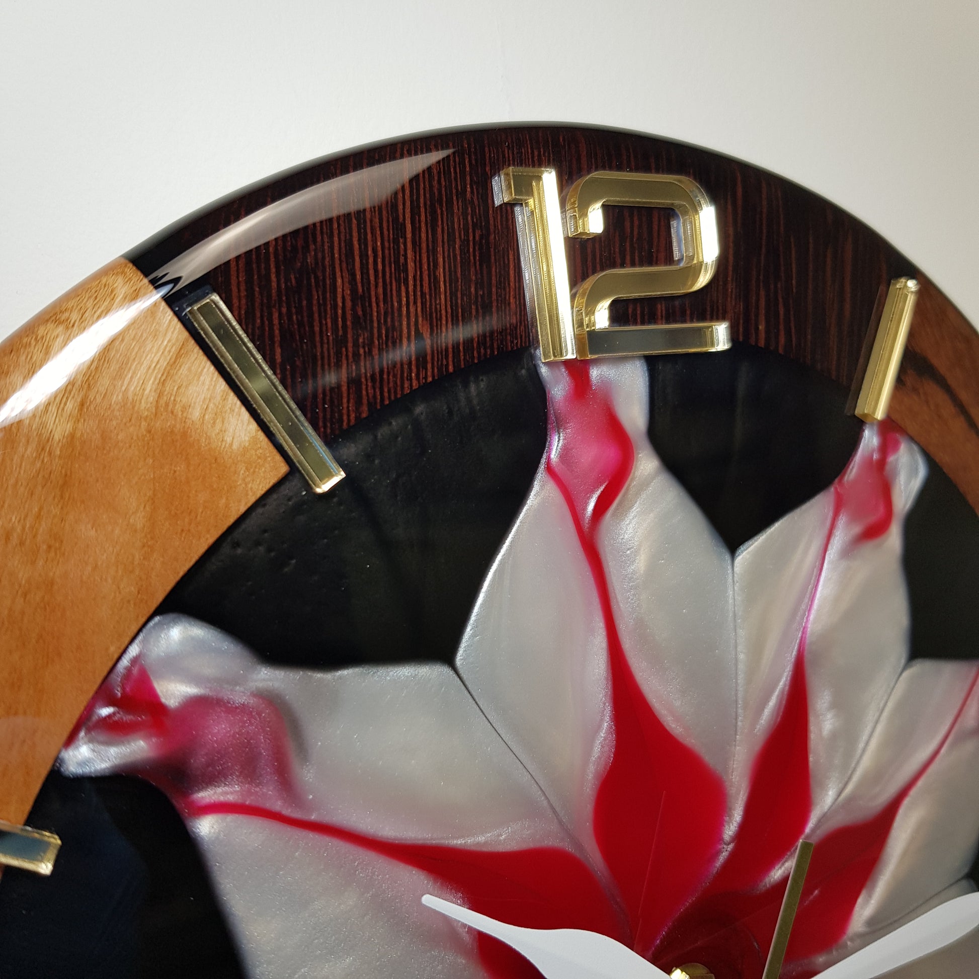 Close-up from the opposite side showing the gold mirrored hour markers and white hands