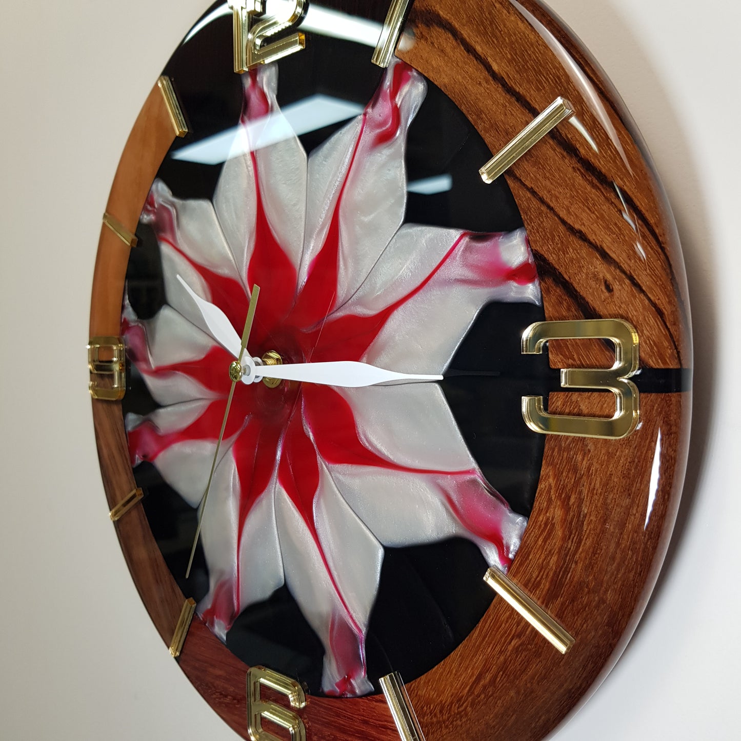 The “Frozen Flame” clock hanging on a white wall, blending elegance and energy