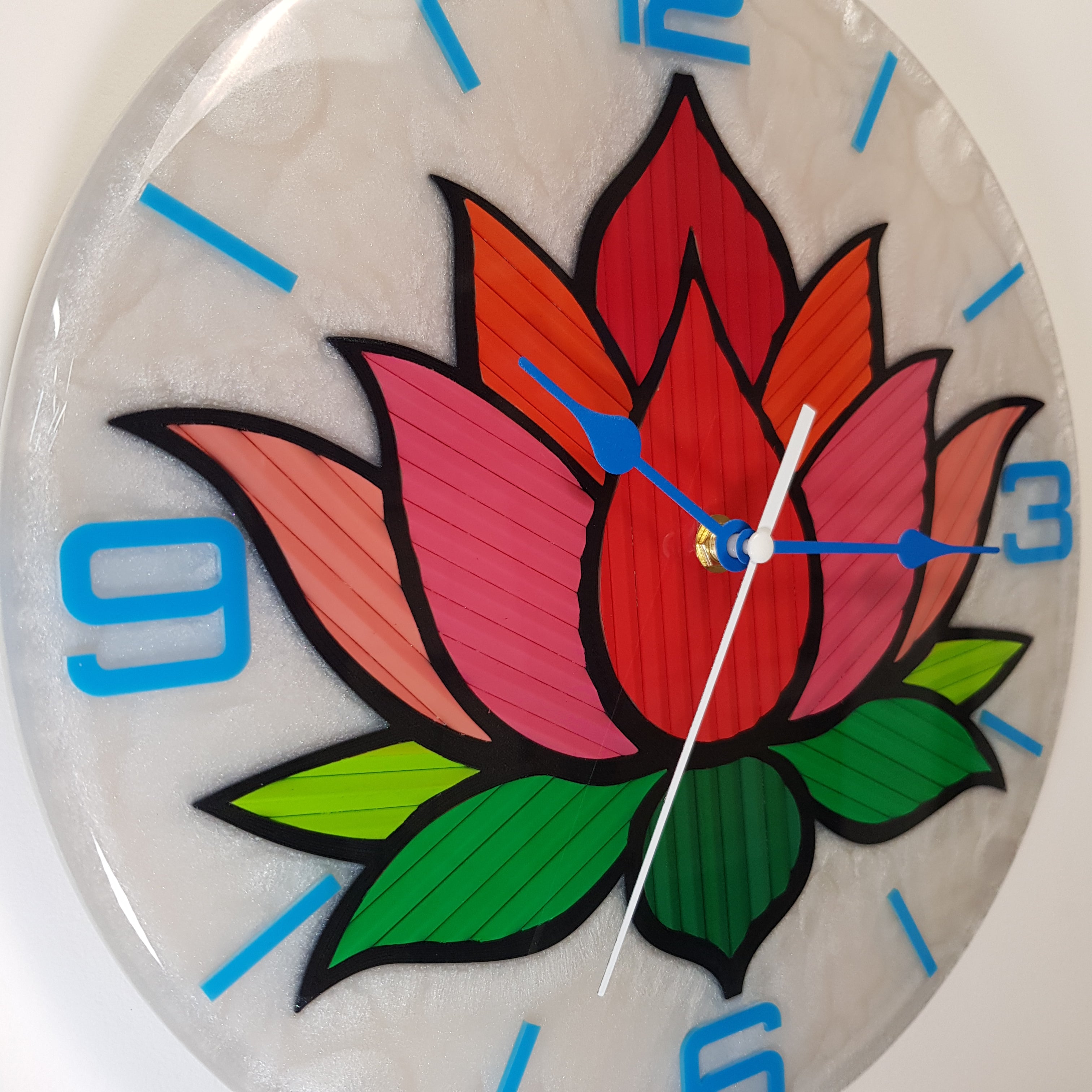 Close-up of the lotus petals revealing vivid red, pink, and green pencil textures under resin