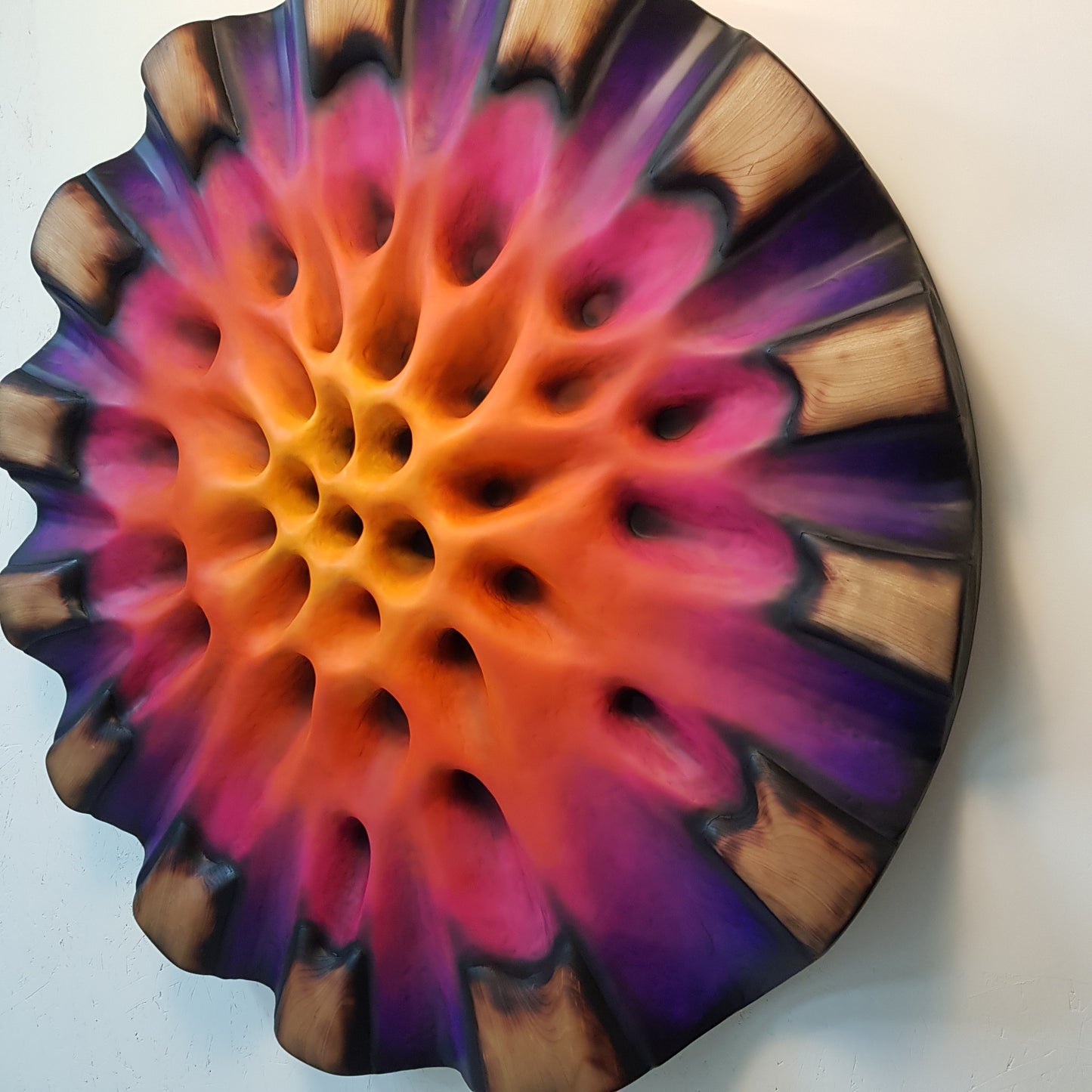 Right side detail of sculpted wooden segments and shadow transitions
