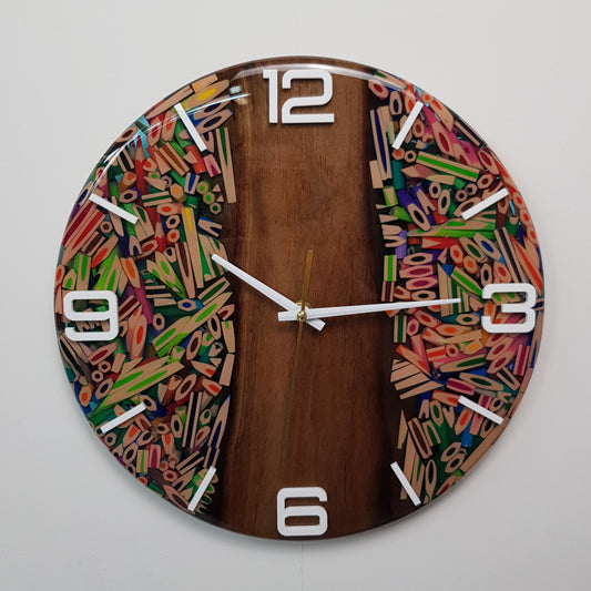 Front view of the “Wood Harmony” wall clock showing walnut wood and colorful pencils set in resin