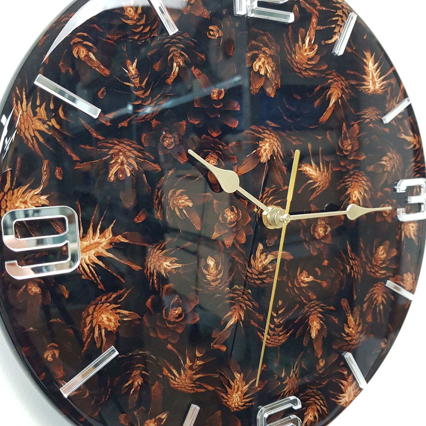 Close-up of the embedded pine cones and glossy black resin surface