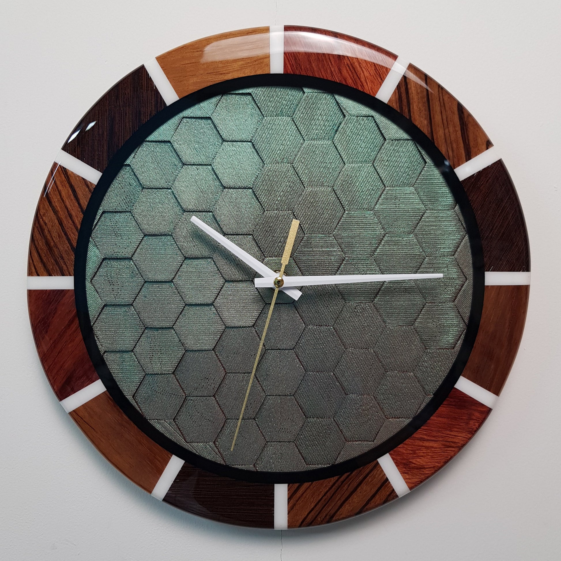 Front view of the “Chromatic Hive” clock showing the full honeycomb center and wooden ring.