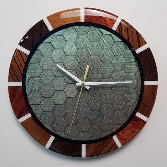 Front view of the “Chromatic Hive” clock showing the full honeycomb center and wooden ring.