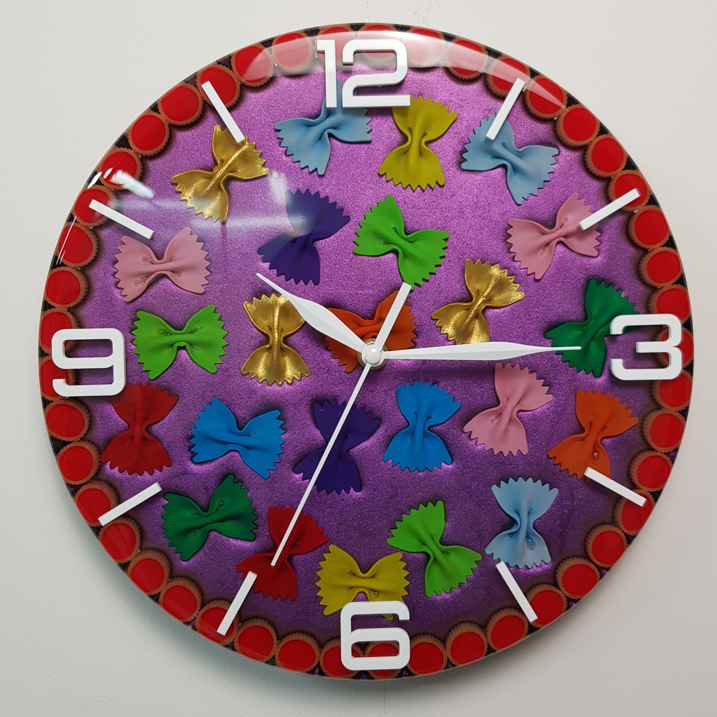 Neon Farfalle handmade wall clock with colorful pasta shapes and pink chameleon background