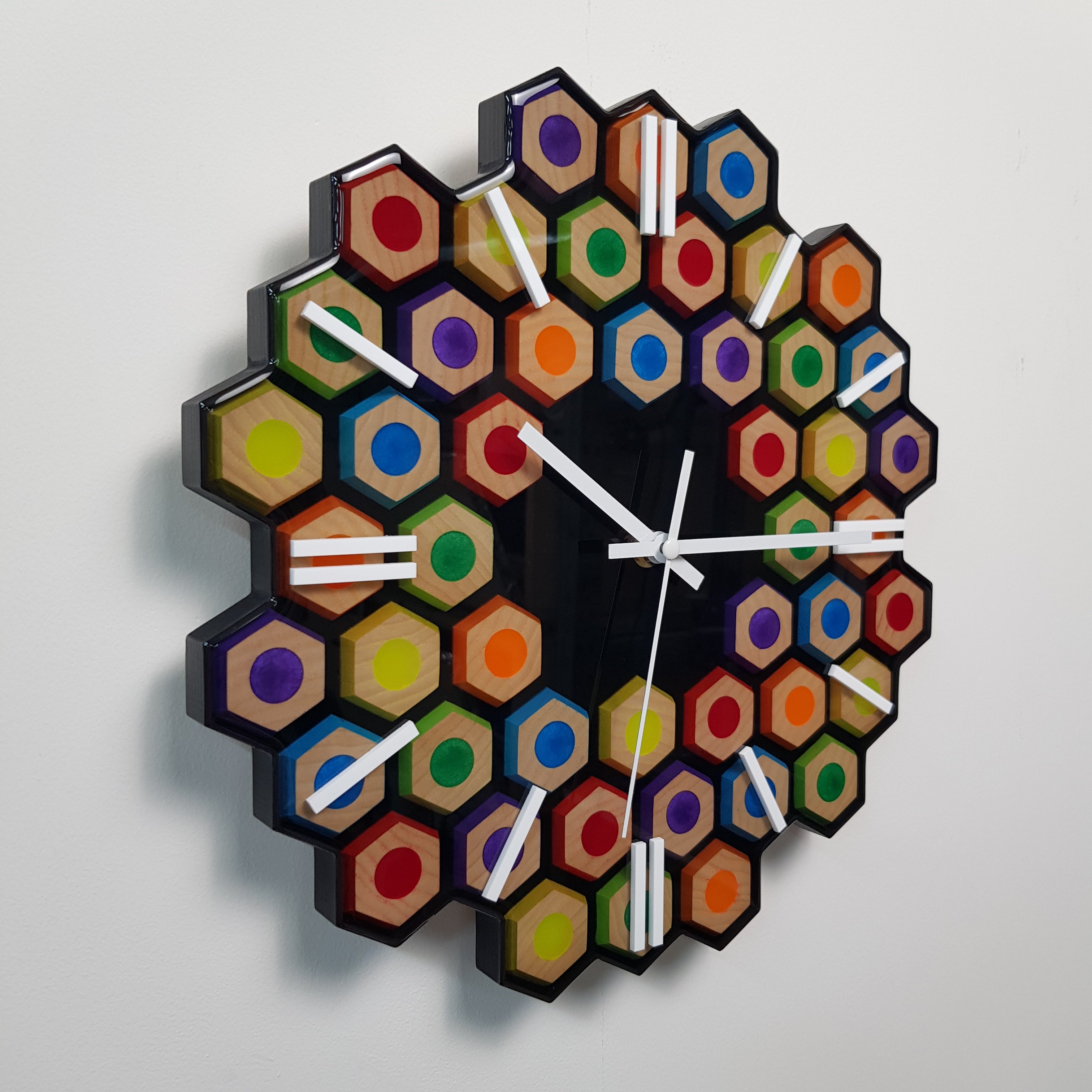 Side angle of handcrafted ash wood resin clock with geometric design