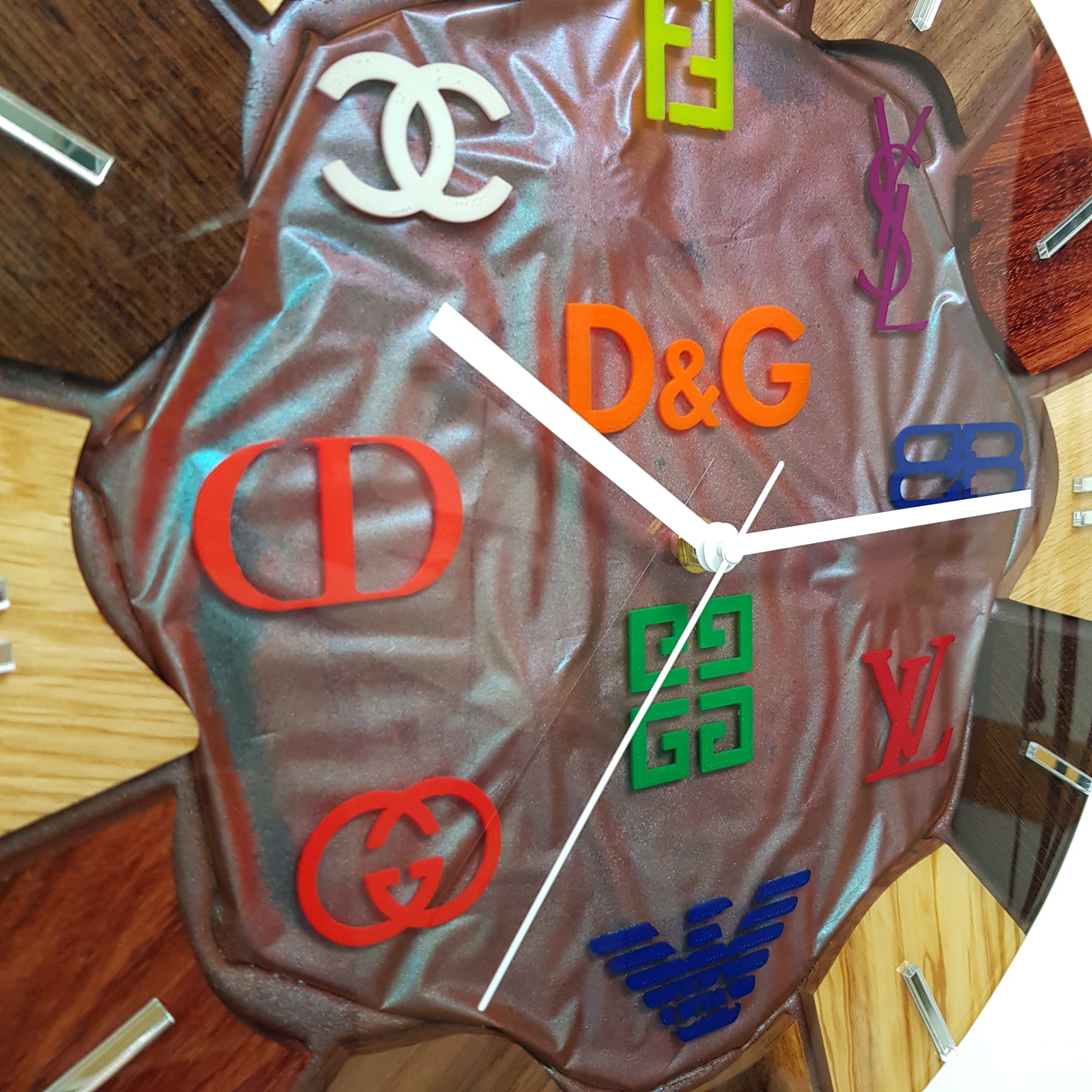 Close-up of the sculpted resin center and artistic symbols of the Noble Spectrum clock.