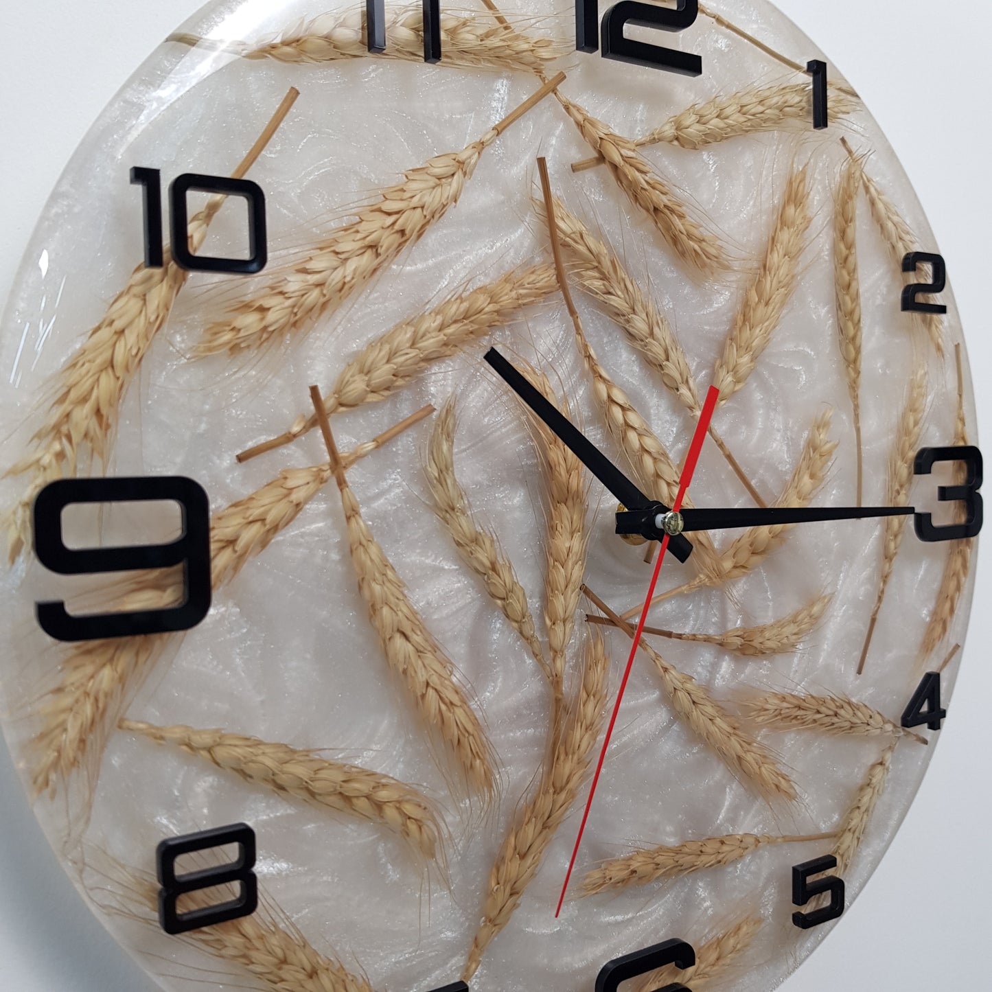 Close-up of the wheat stalks and black numerals inside the epoxy resin surface.