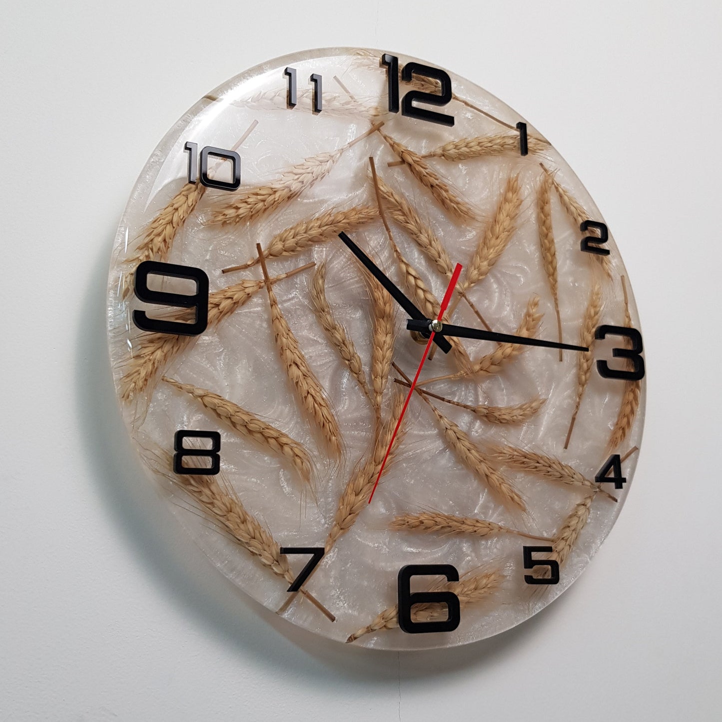 Perspective view showing depth, natural wheat elements, and the contrast between the pearlescent base and black numbers.