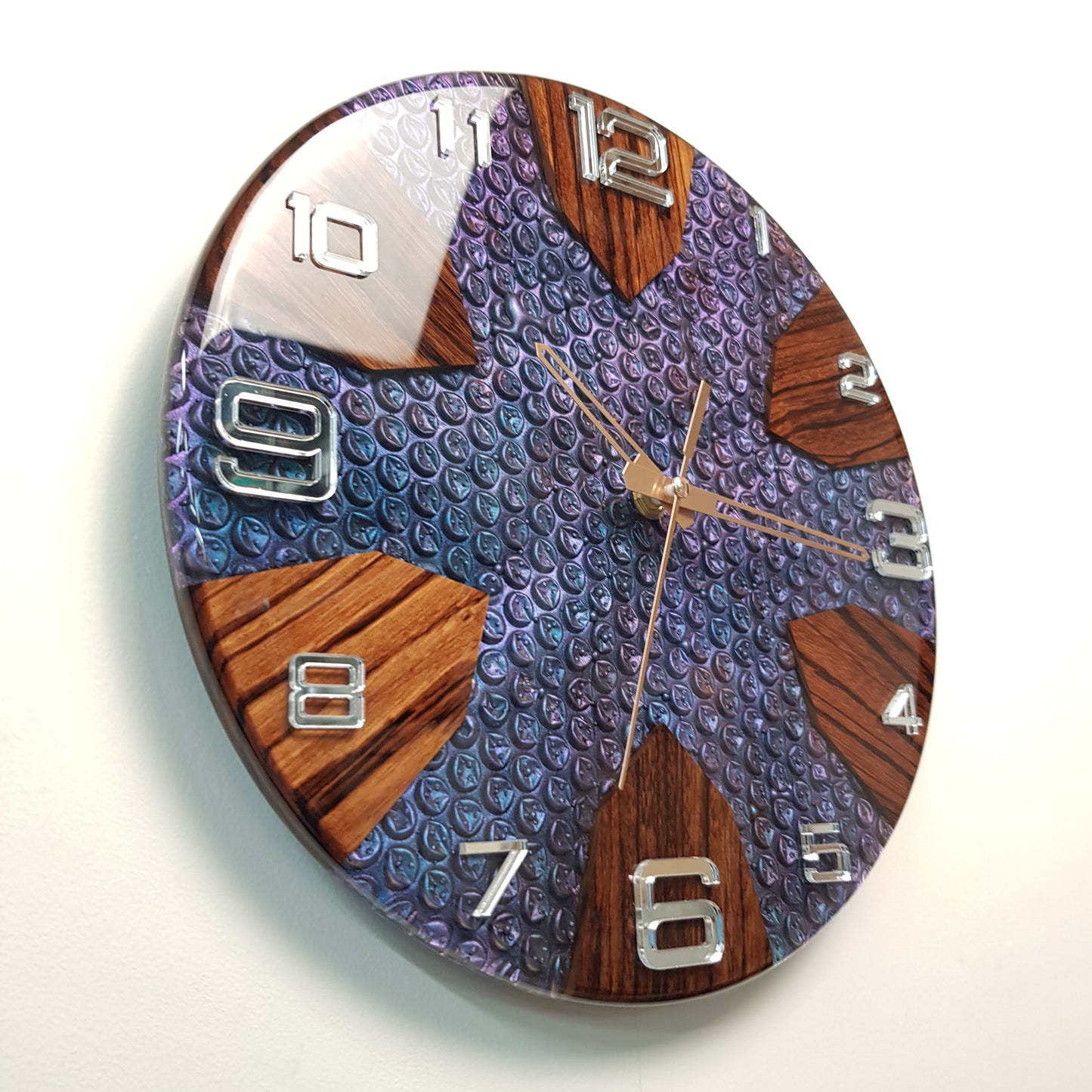 Full front view of the clock displaying mirrored acrylic numbers and zebrawood sections.