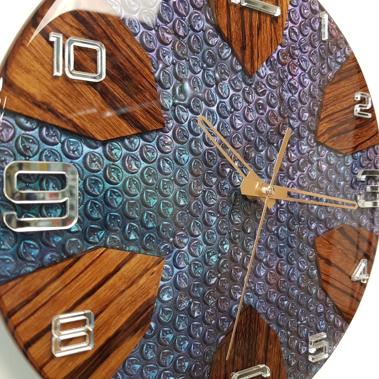 Close-up of the “Chromatic Bubbles” clock showing the bubble-texture resin surface and zebrawood accents.