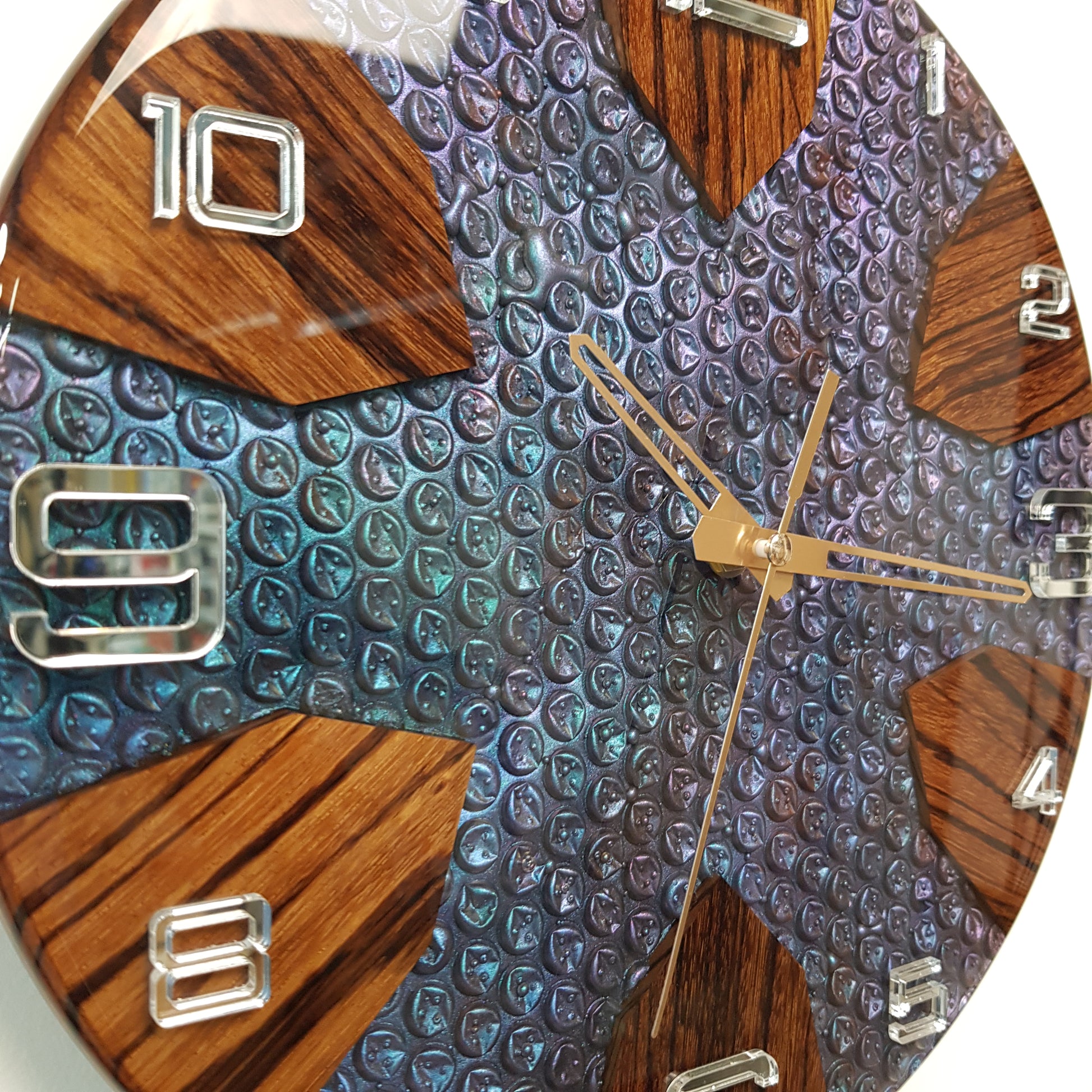 Close-up of the “Chromatic Bubbles” clock showing the bubble-texture resin surface and zebrawood accents.