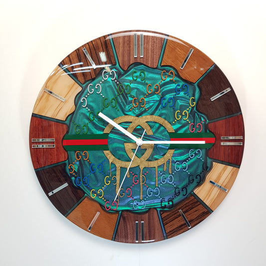 Front view of the “Emerald Flow” wall clock — natural wood segments with emerald chameleon resin and mirrored hour markers