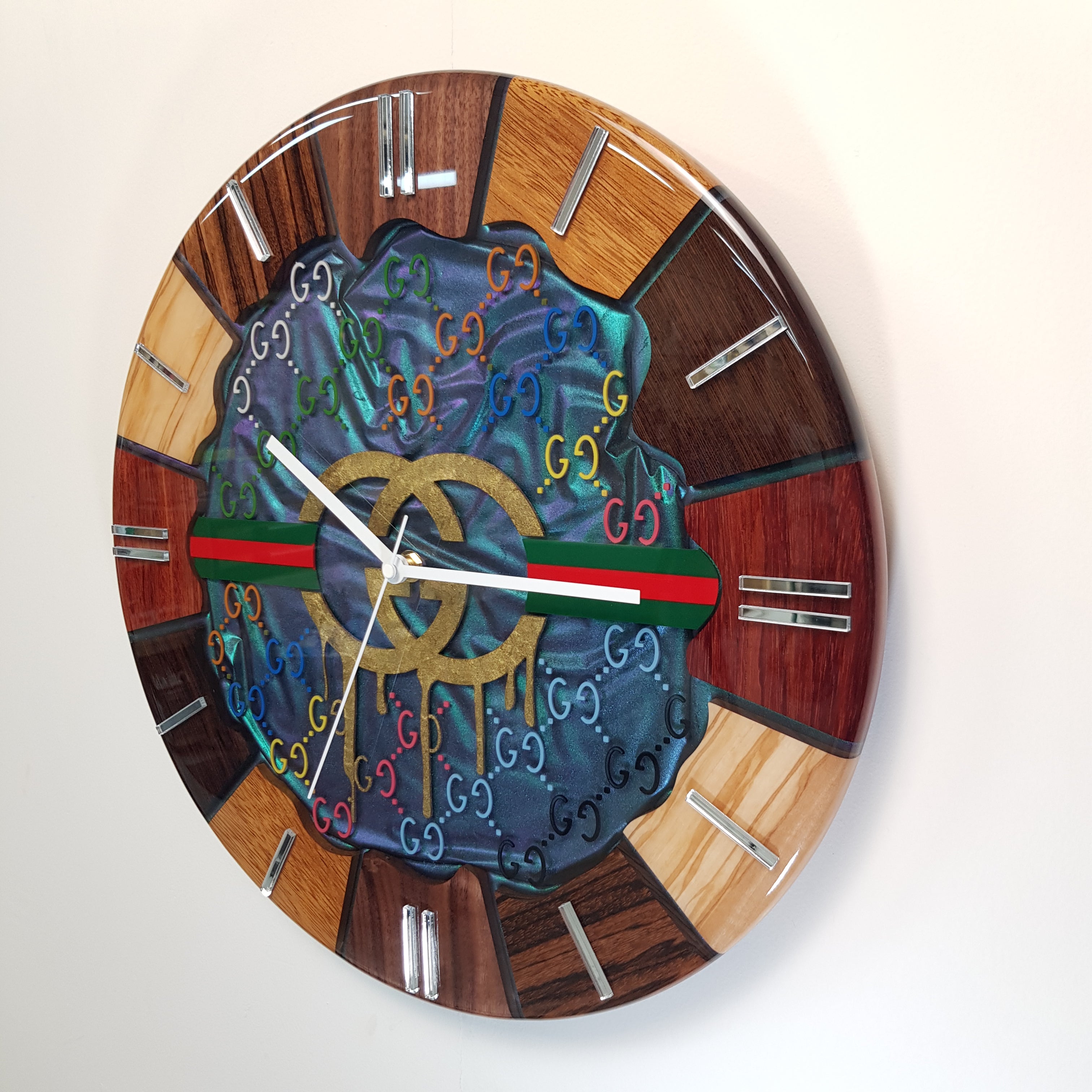Side perspective of the clock mounted on the wall — showing wood grain, resin depth and golden hands