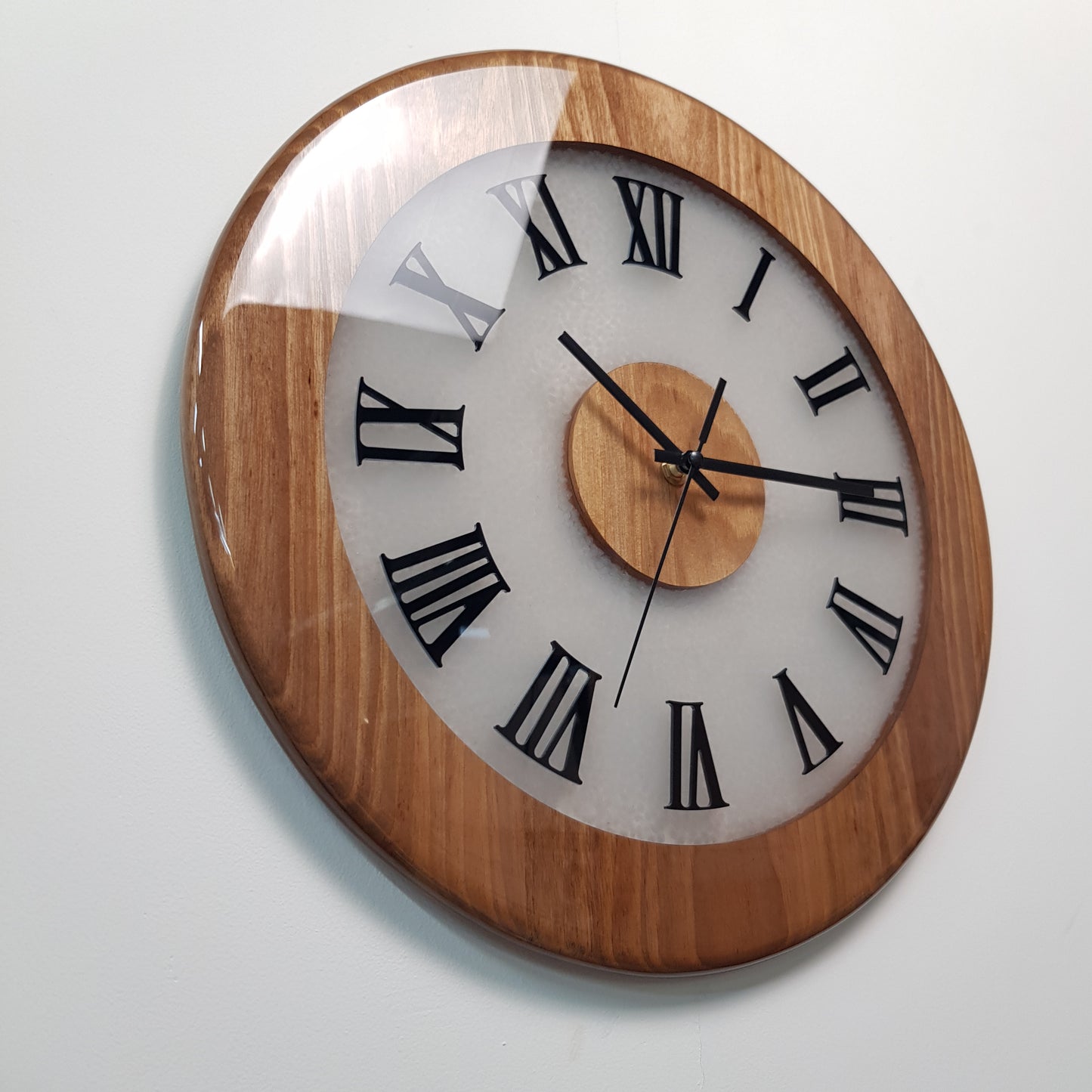 Close-up angled view highlighting walnut wood texture and black plexiglass Roman markers.