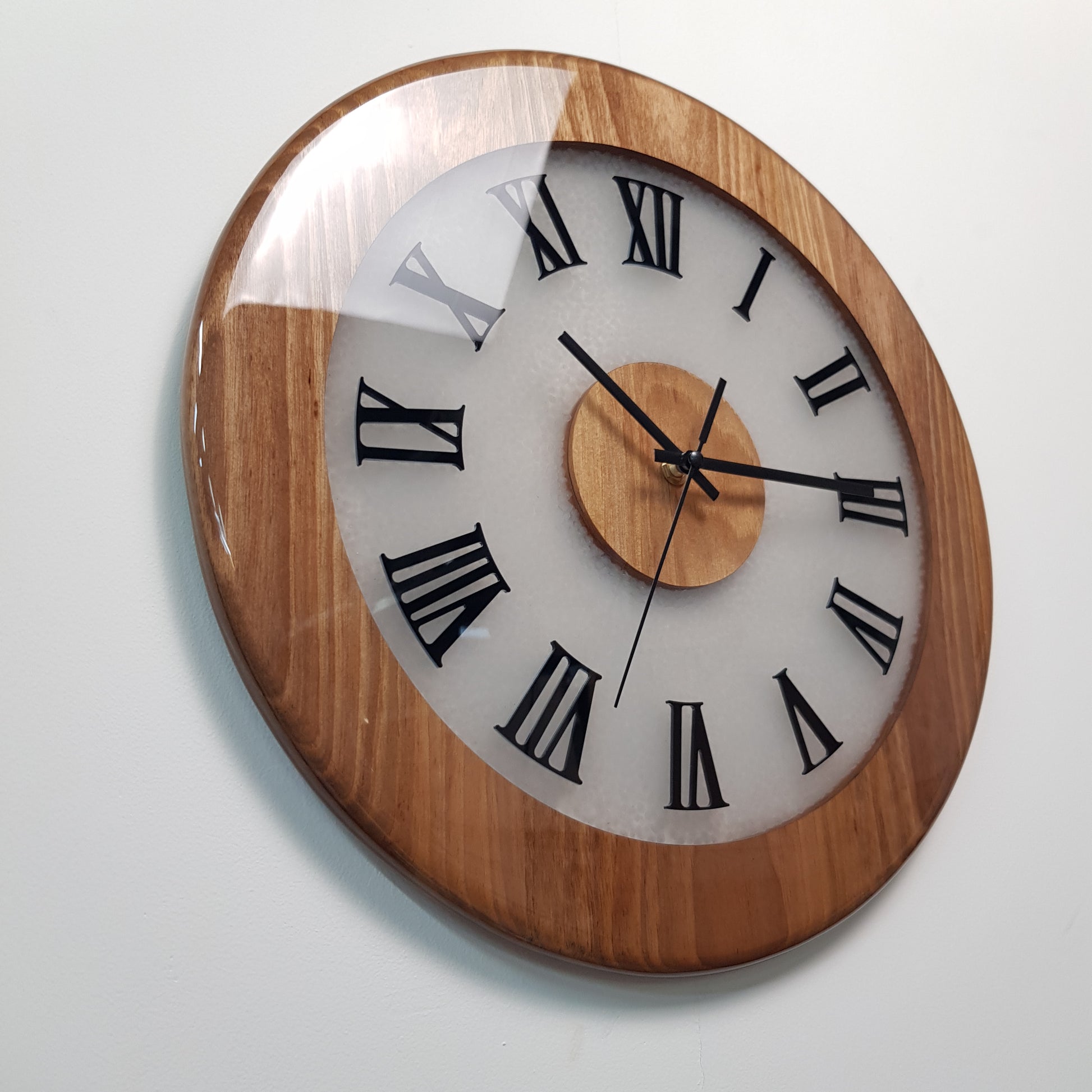 Close-up angled view highlighting walnut wood texture and black plexiglass Roman markers.