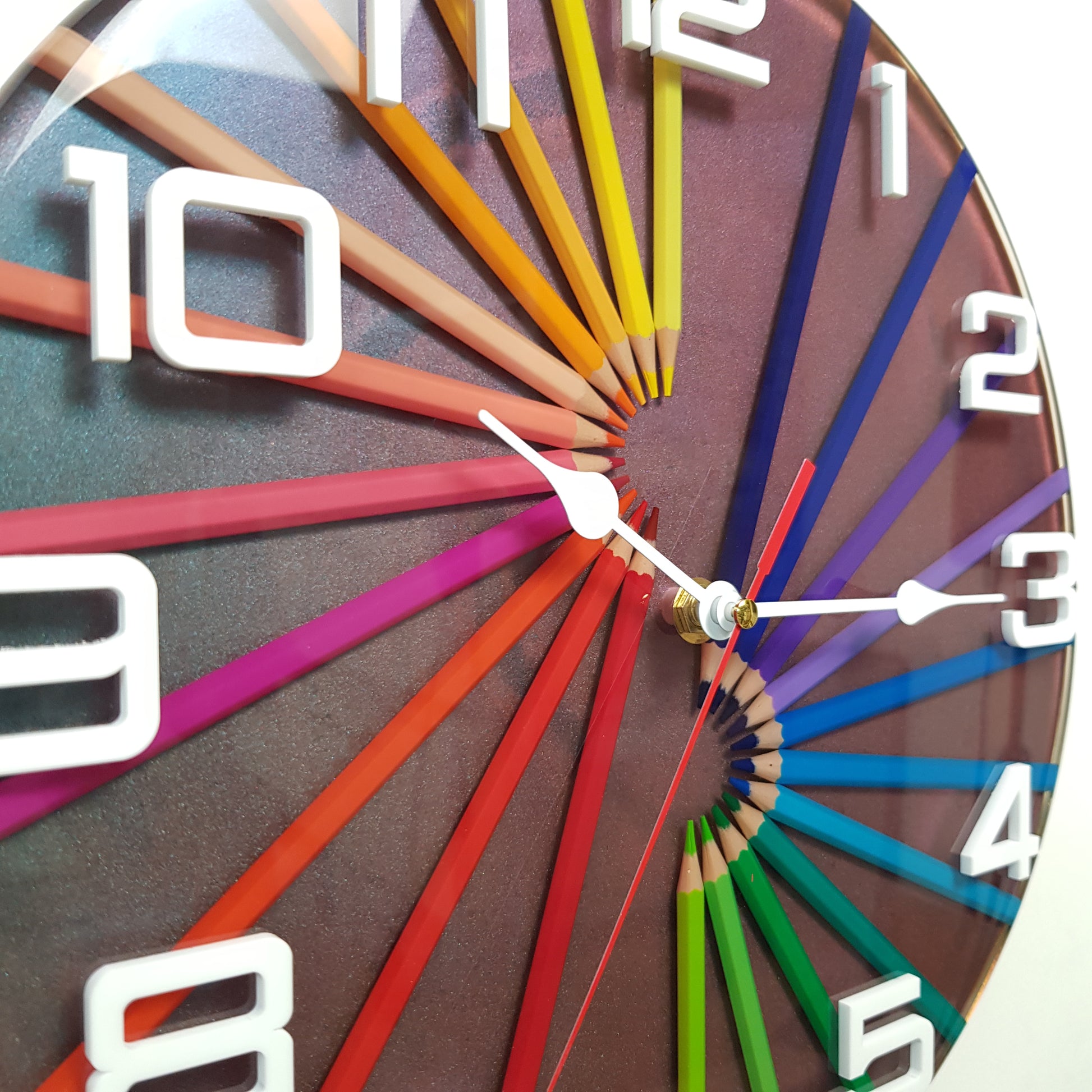 Close-up side view showing real coloured pencils encased in epoxy resin