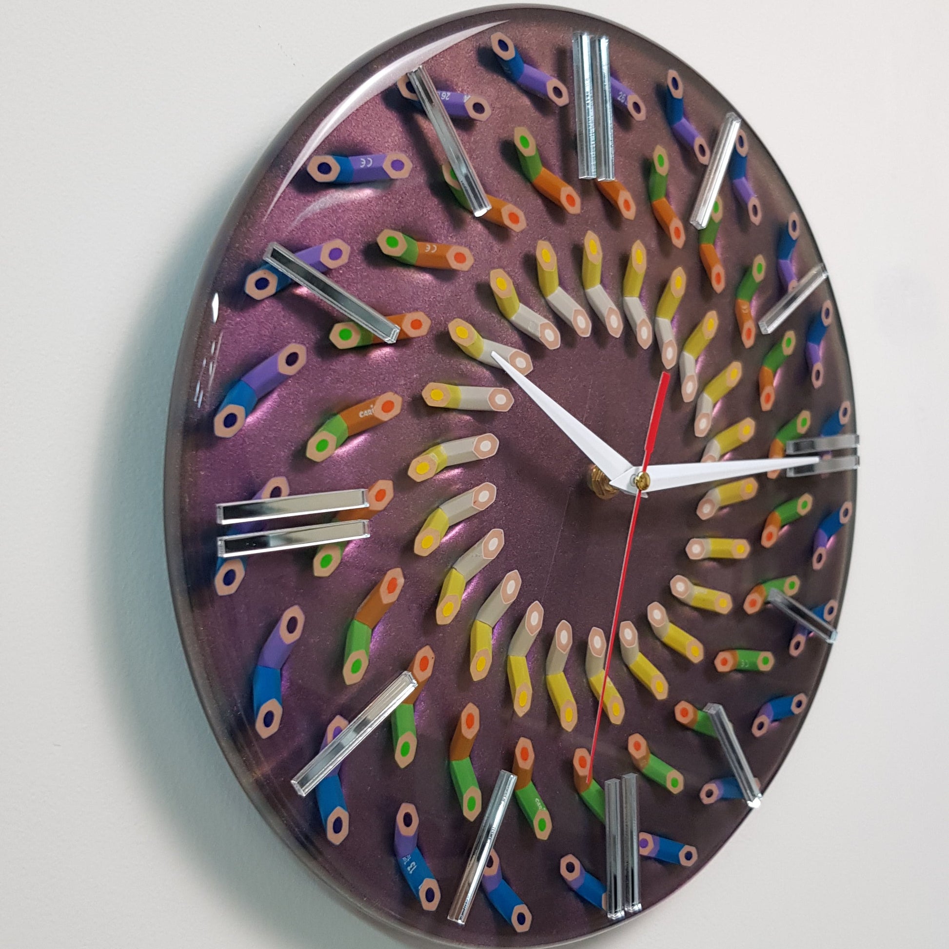 Close-up of spiral pencil composition on a color-shifting resin surface