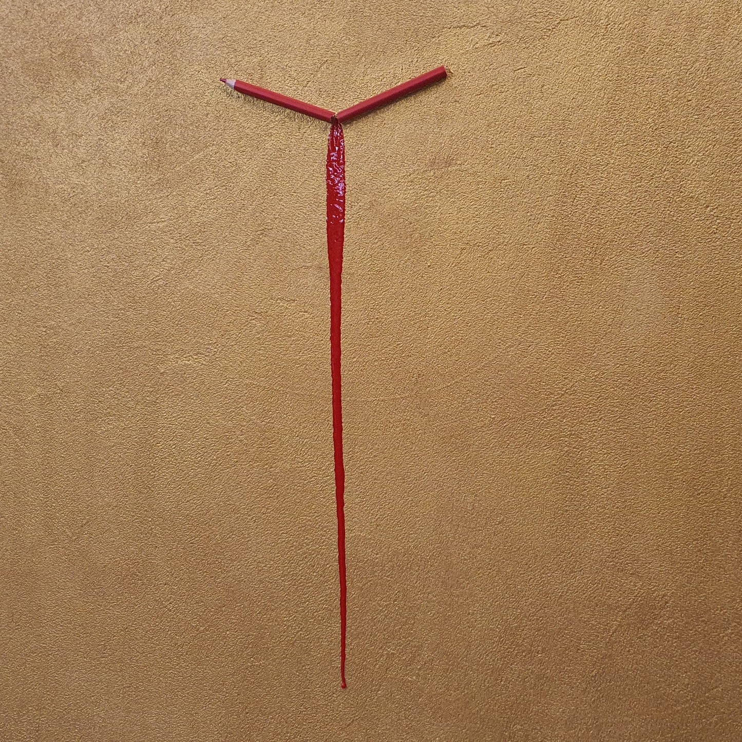 Un Capitolo Nuovo collectible conceptual artwork – symbolic broken pencil and resin on golden surface, close-up