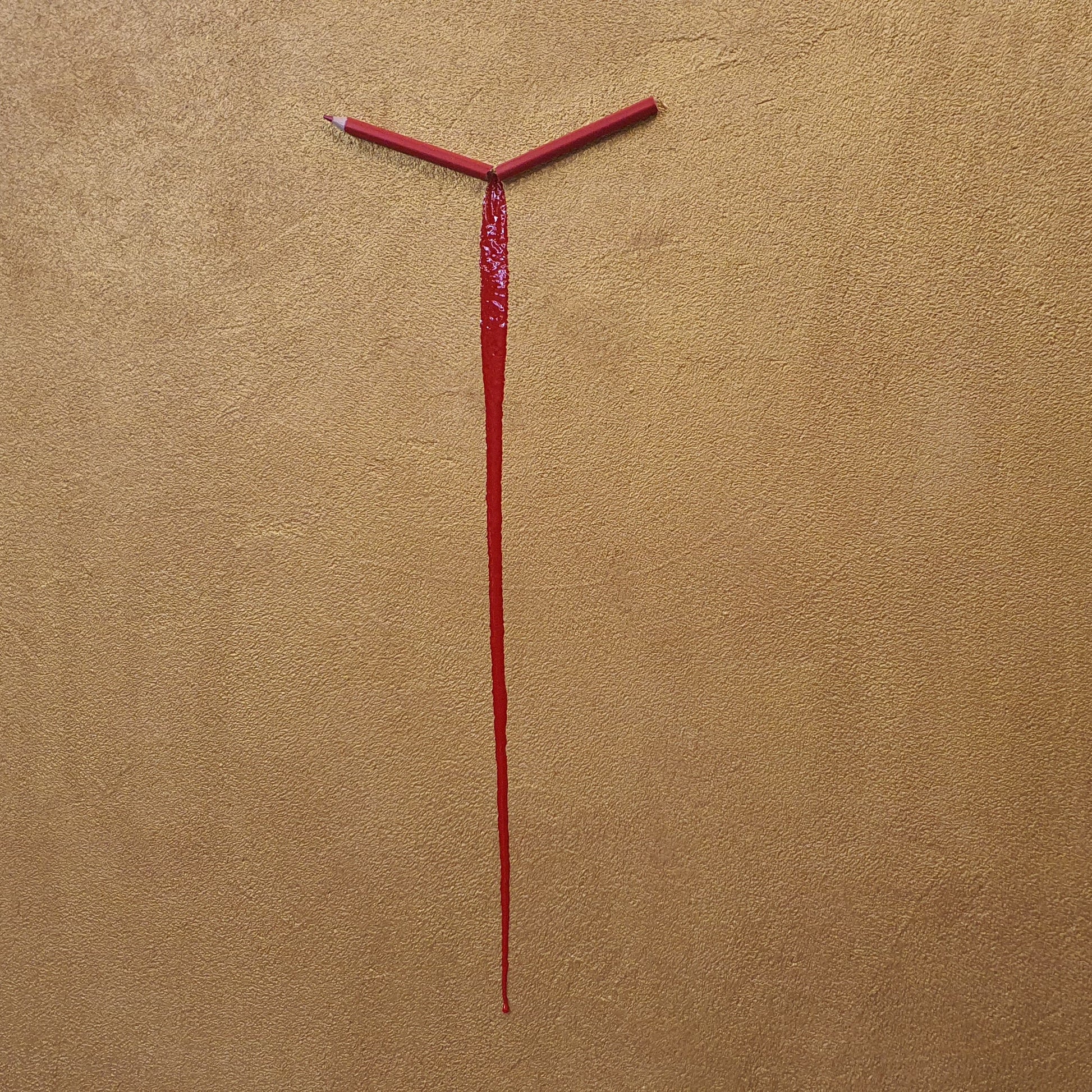 Un Capitolo Nuovo collectible conceptual artwork – symbolic broken pencil and resin on golden surface, close-up