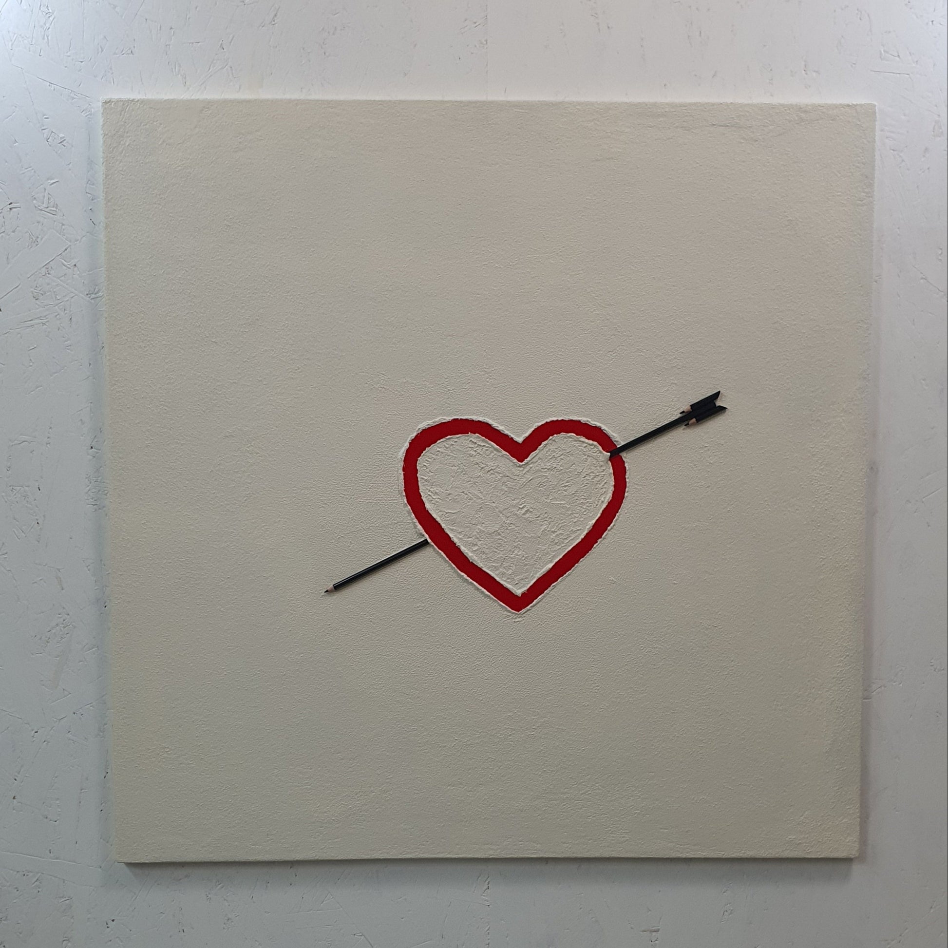 La Matita nel Cuore resin and pencil artwork – conceptual close-up showing red heart pierced by black pencil