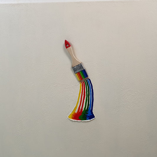 La Forza del Colore conceptual artwork – paintbrush transformed into rainbow of colored pencils, front view