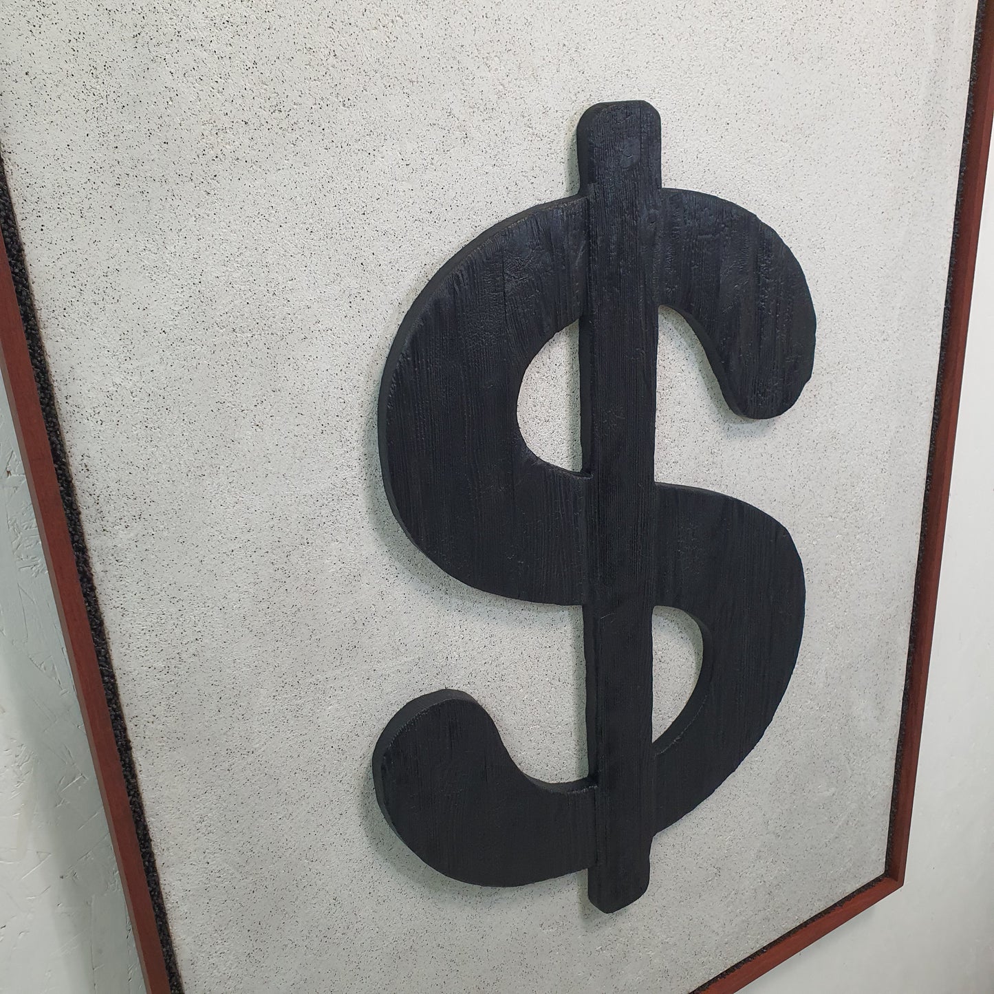Unique contemporary art piece Icona Bruciata – handmade mixed media installation with scorched wood and dollar sign, angled photo