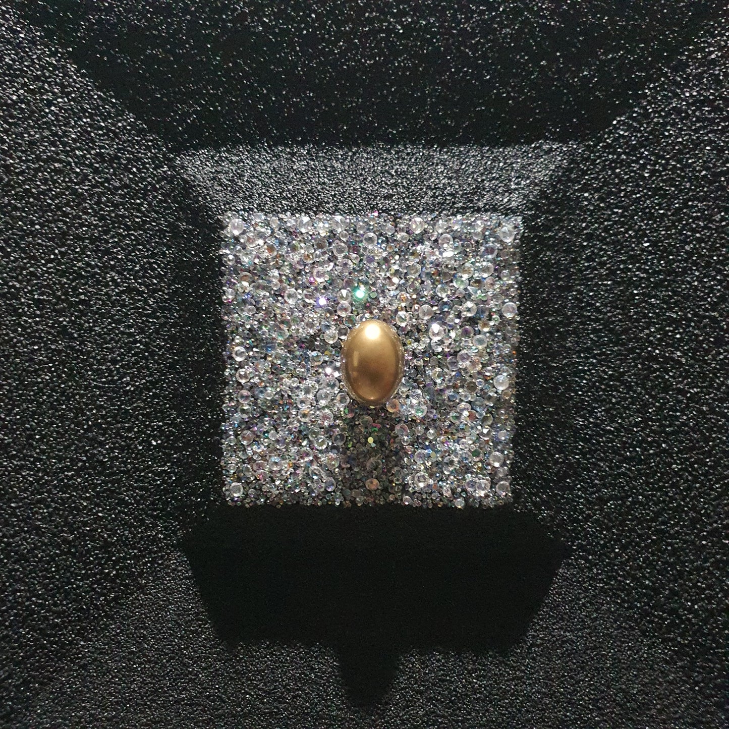 La Verità Nascosta resin and quartz stone artwork – close-up detail of golden egg inside sparkling crystal block