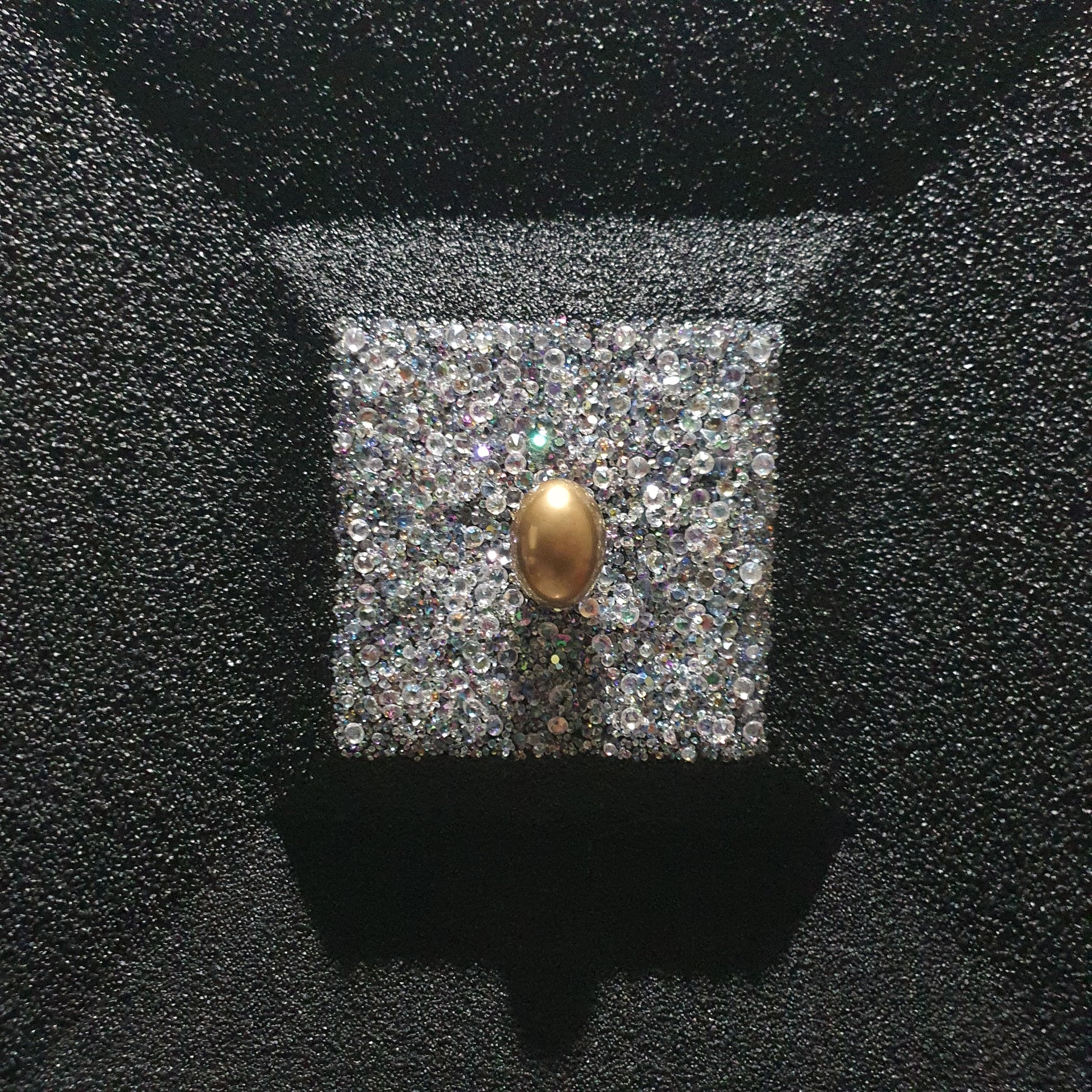 La Verità Nascosta resin and quartz stone artwork – close-up detail of golden egg inside sparkling crystal block