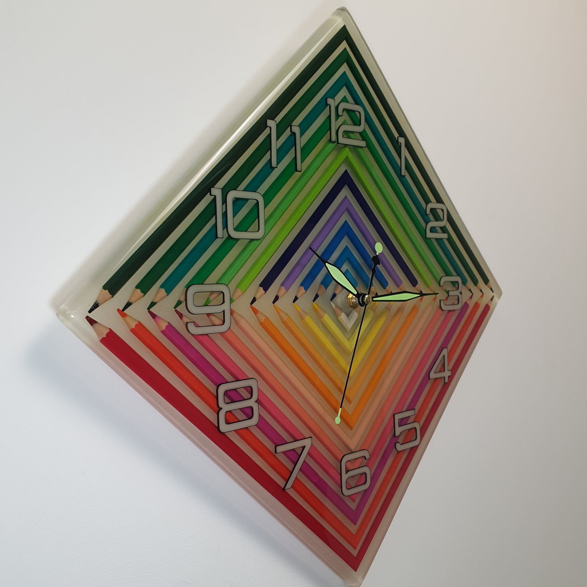 Detailed side shot of the glowing rainbow resin clock with number cut-outs