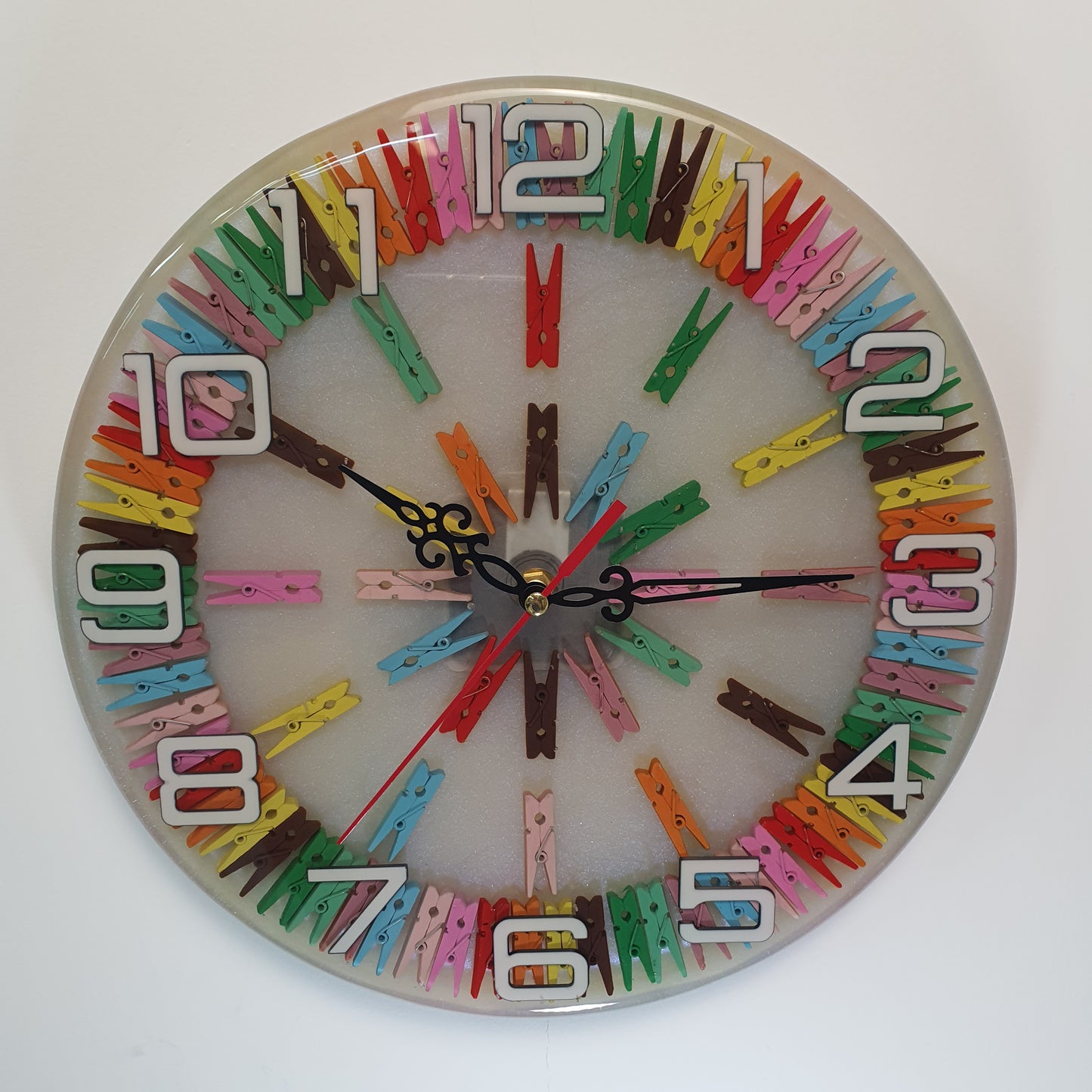 Front view of the Happy Pegs epoxy wall clock with colorful pegs