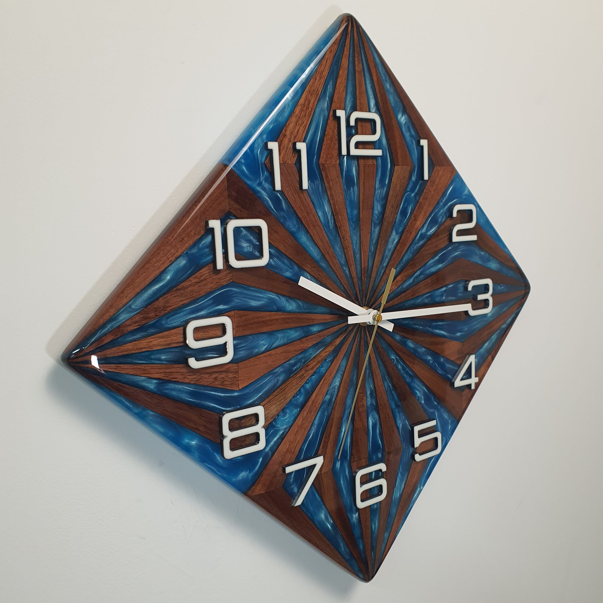 Diagonal close-up of Walnut Wave wall clock highlighting depth, texture, and precision of handmade design