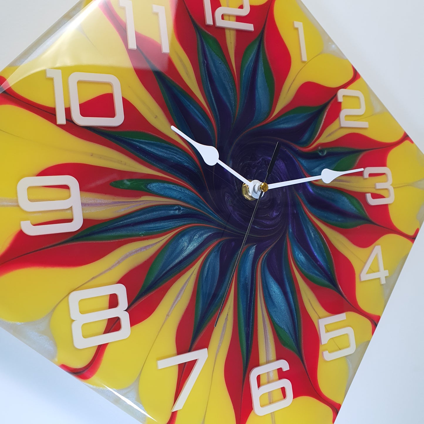Close-up of Spiral Bloom clock face showing resin texture and vibrant spiral pattern