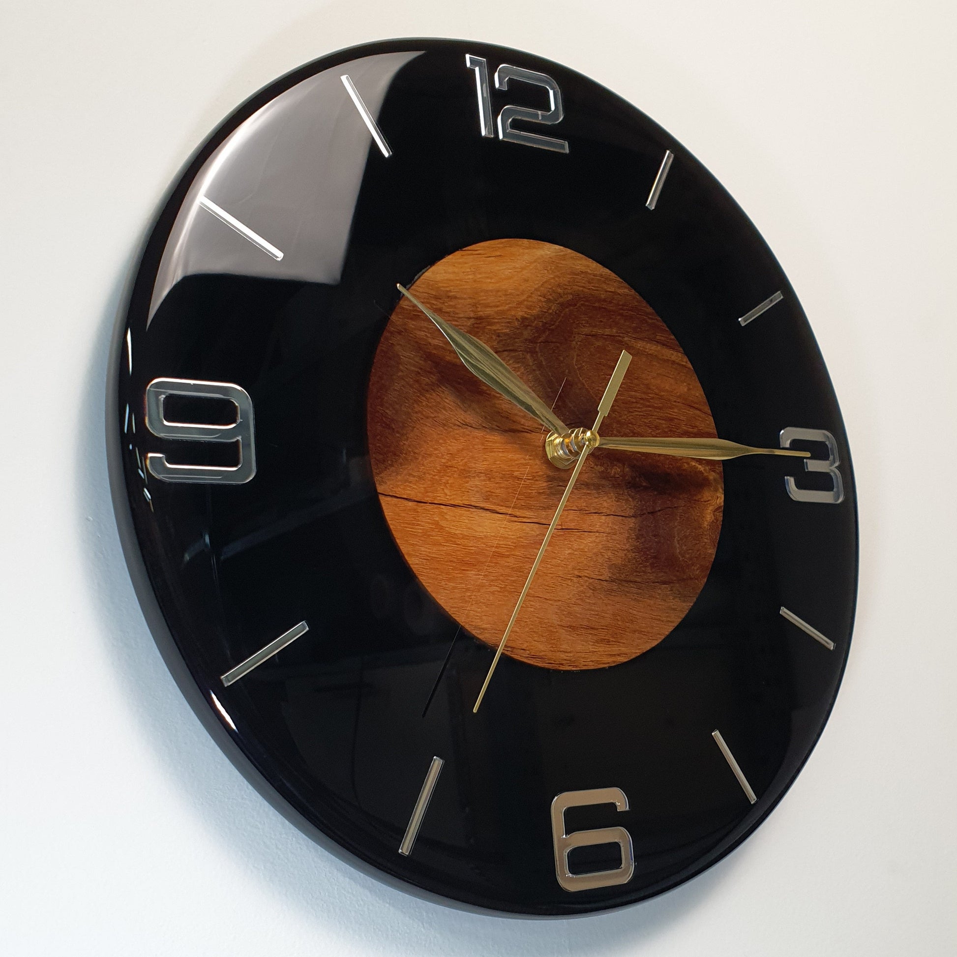 Right side view showing the gold clock hands and depth of the black resin